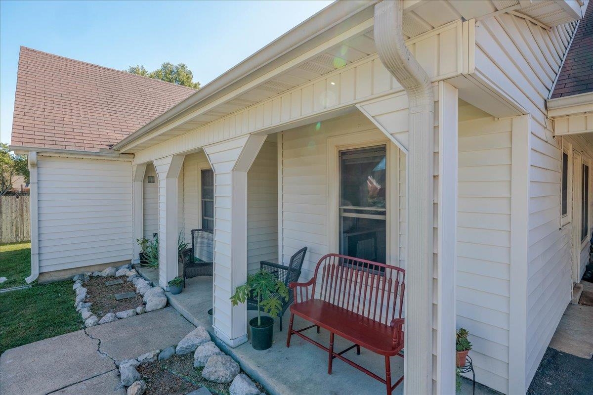 Doorway to property with covered porch