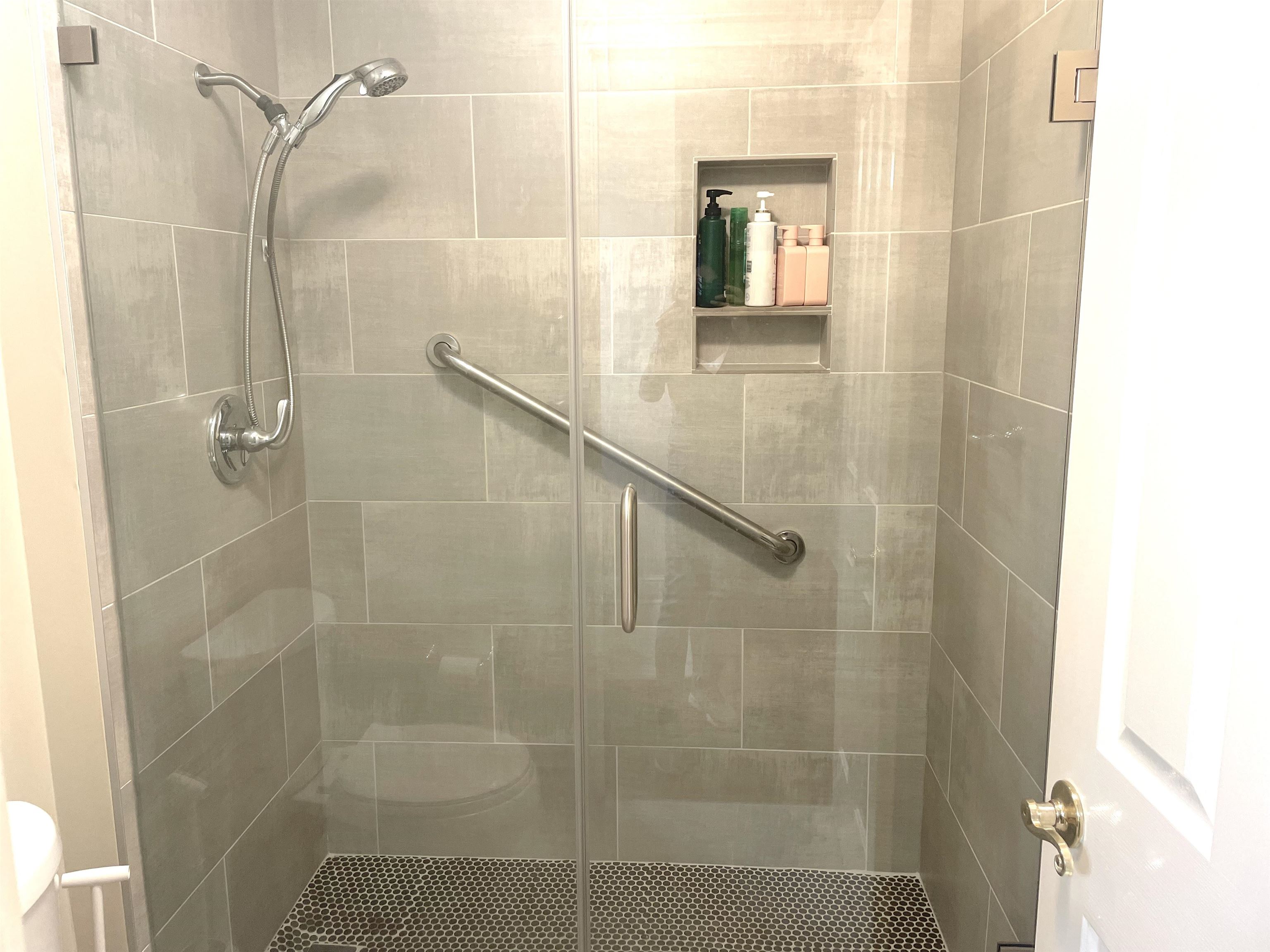 Wonderful walk-in tiled shower with glass doors