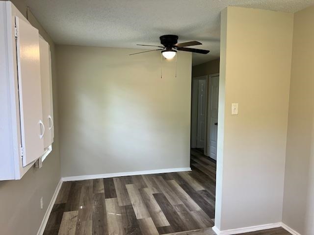 Dining area featuring ceiling fan, dark hardwood / wood-style flooring