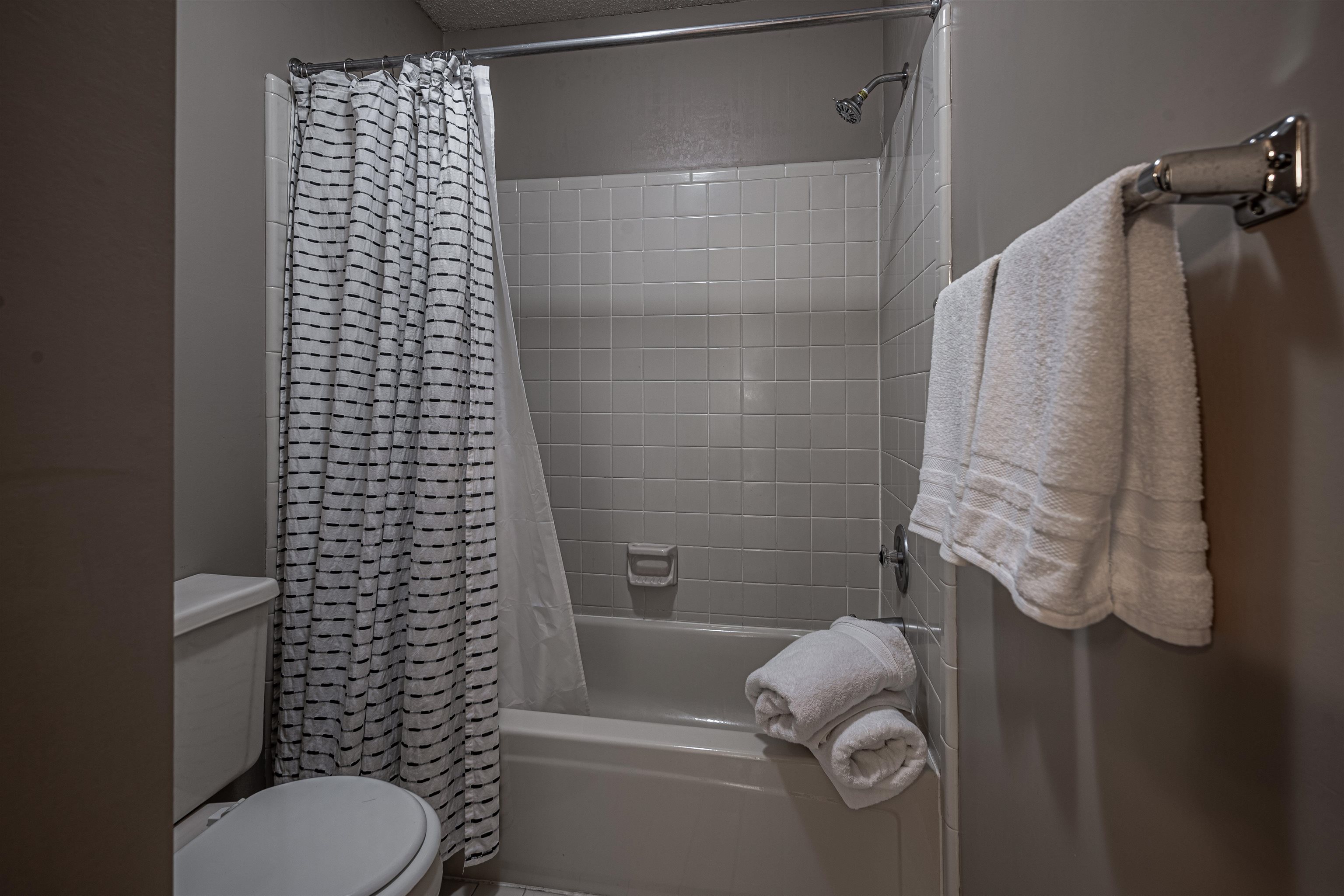 Bathroom featuring shower / bath combo and toilet