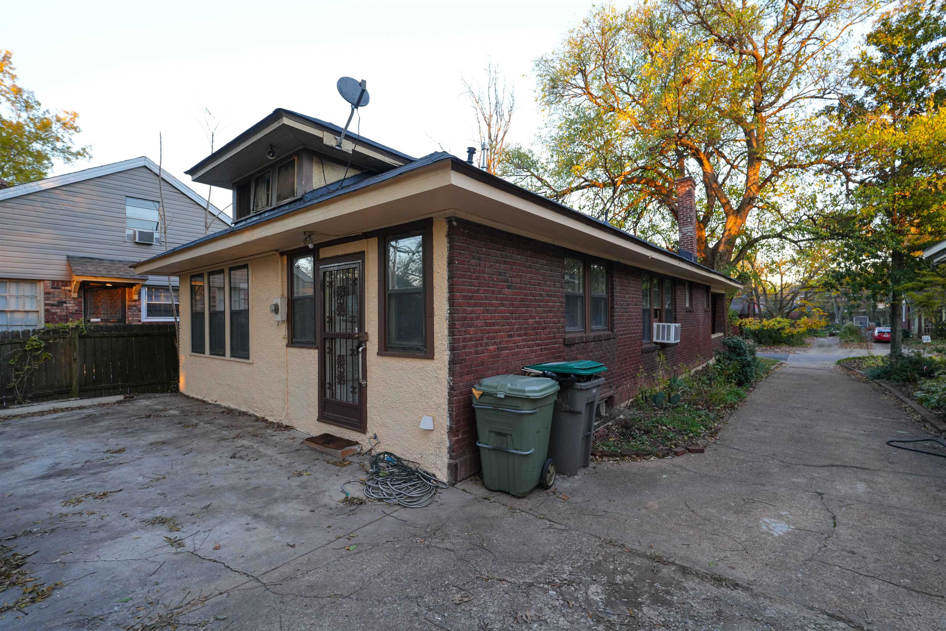 Rear view of house featuring cooling unit