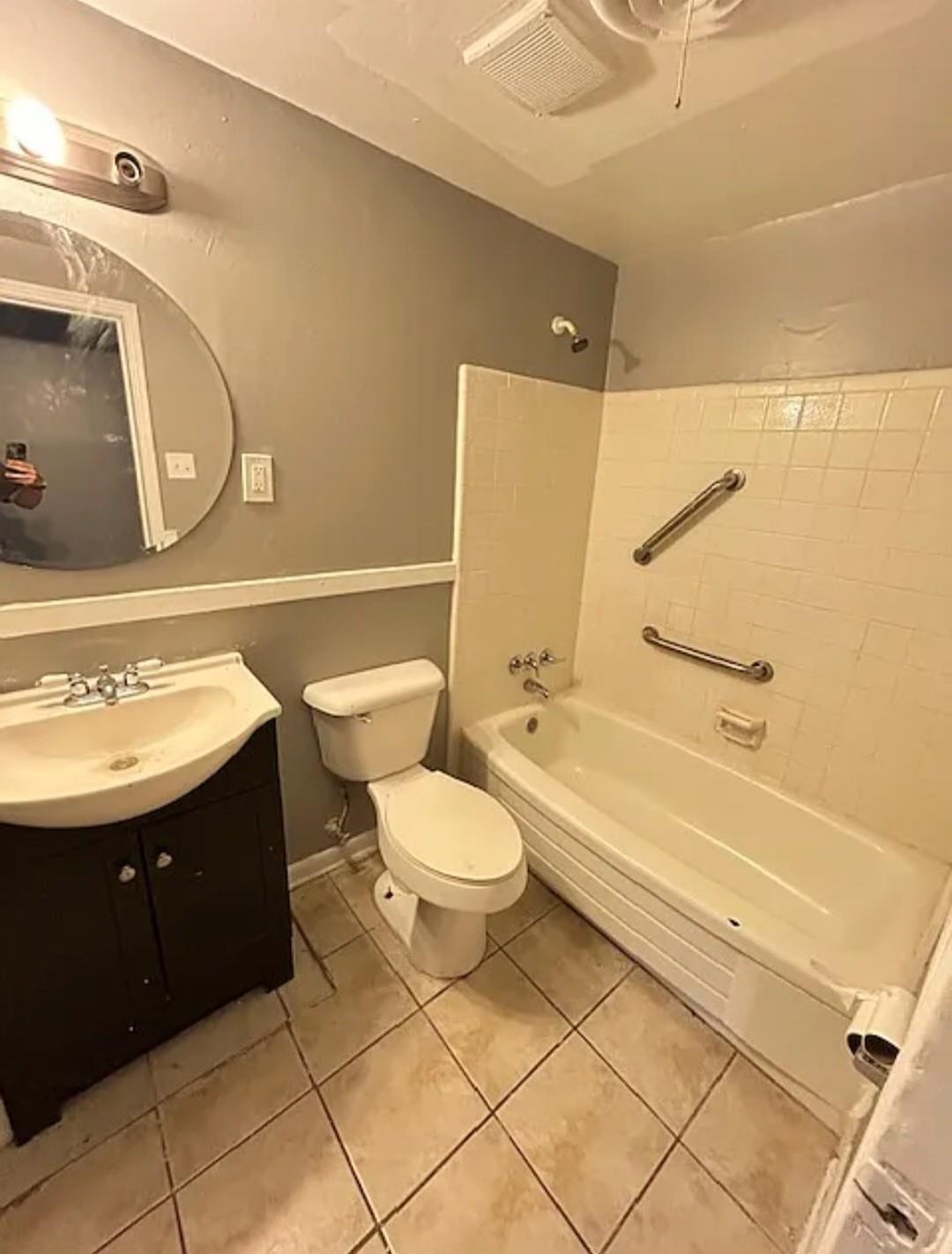 Full bathroom featuring shower / tub combination, tile patterned flooring, vanity, and toilet