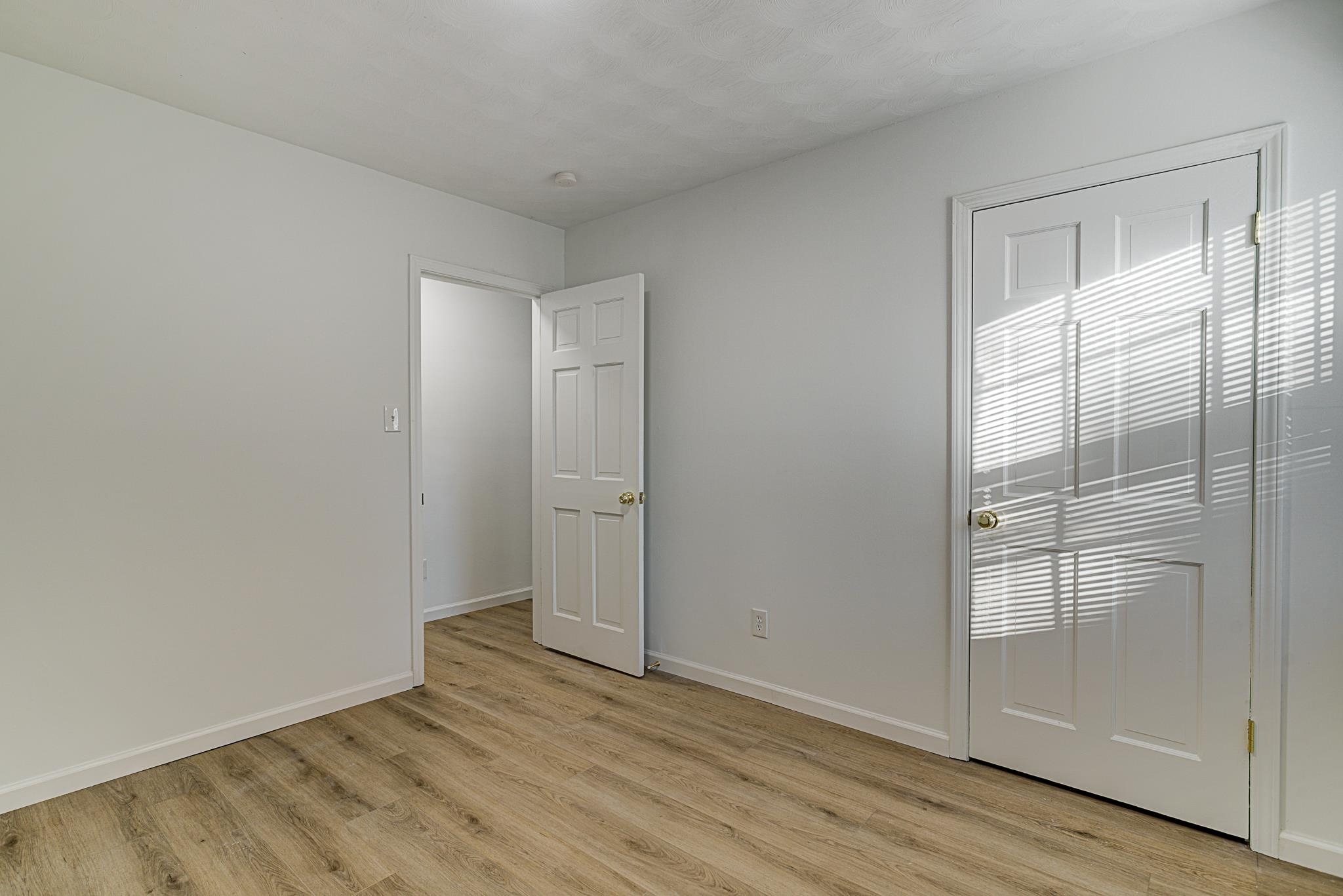 Spare room featuring light laminate / wood-style flooring