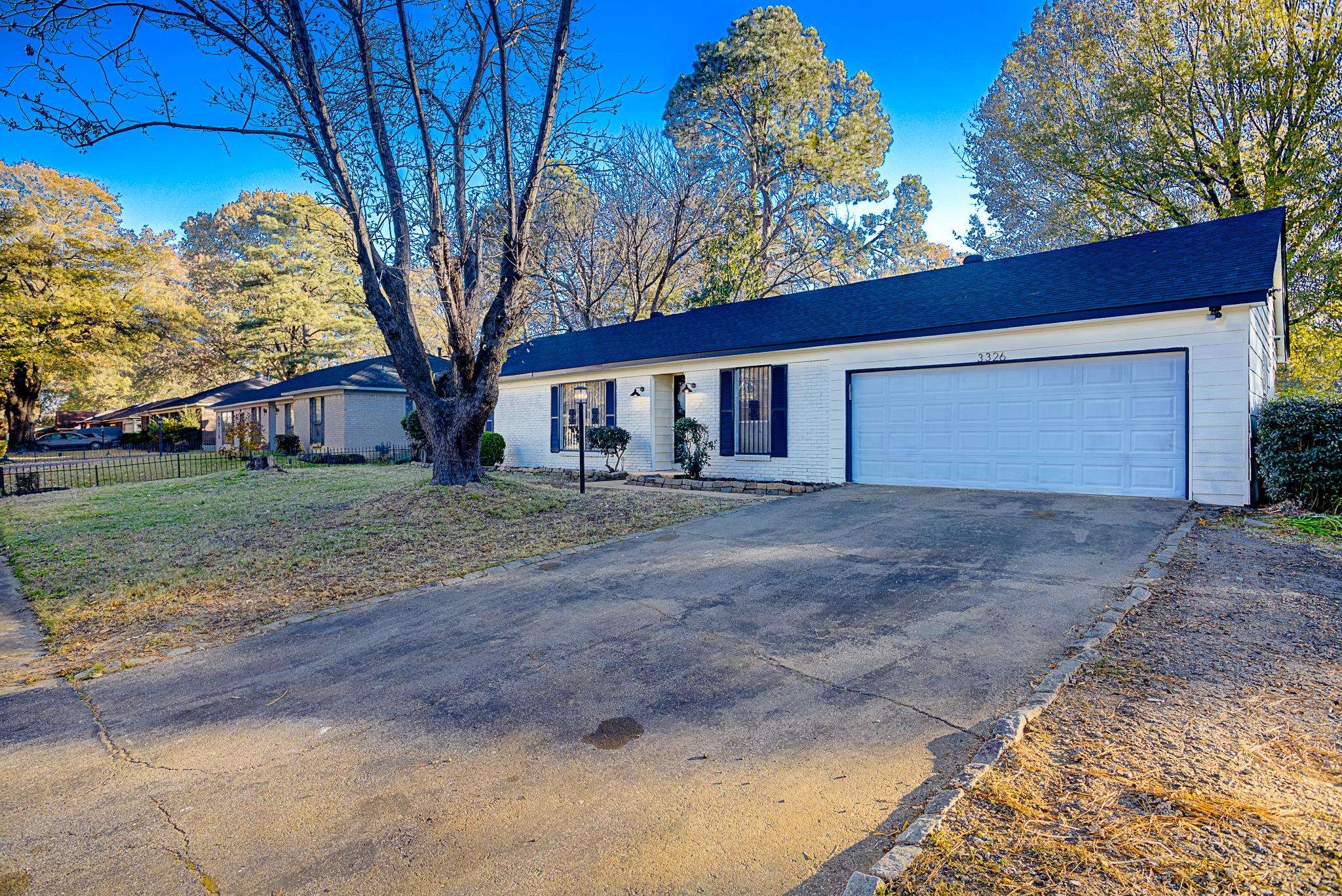 Ranch-style house with a garage and a front yard