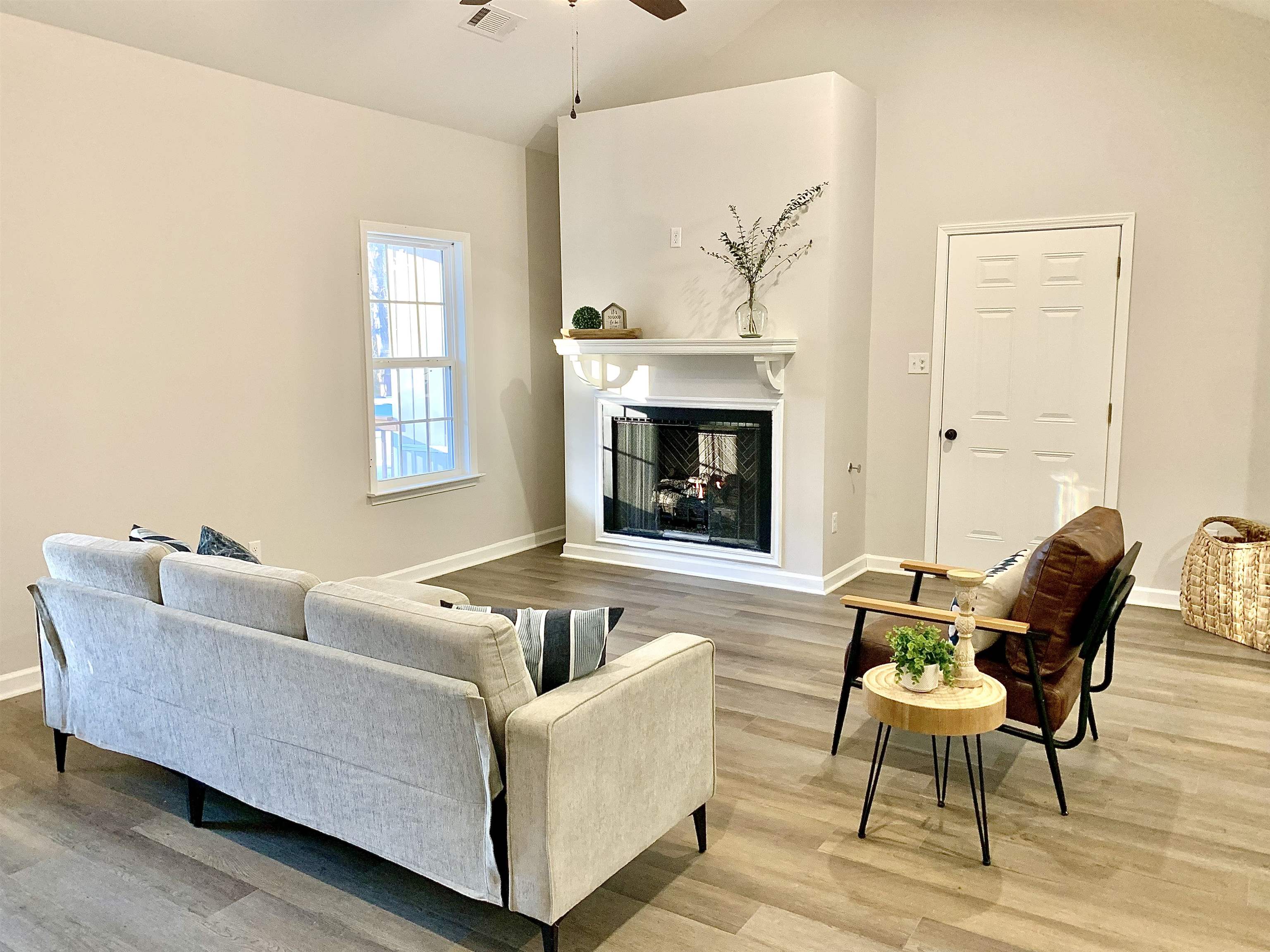 Living room with ceiling fan and wood-type flooring