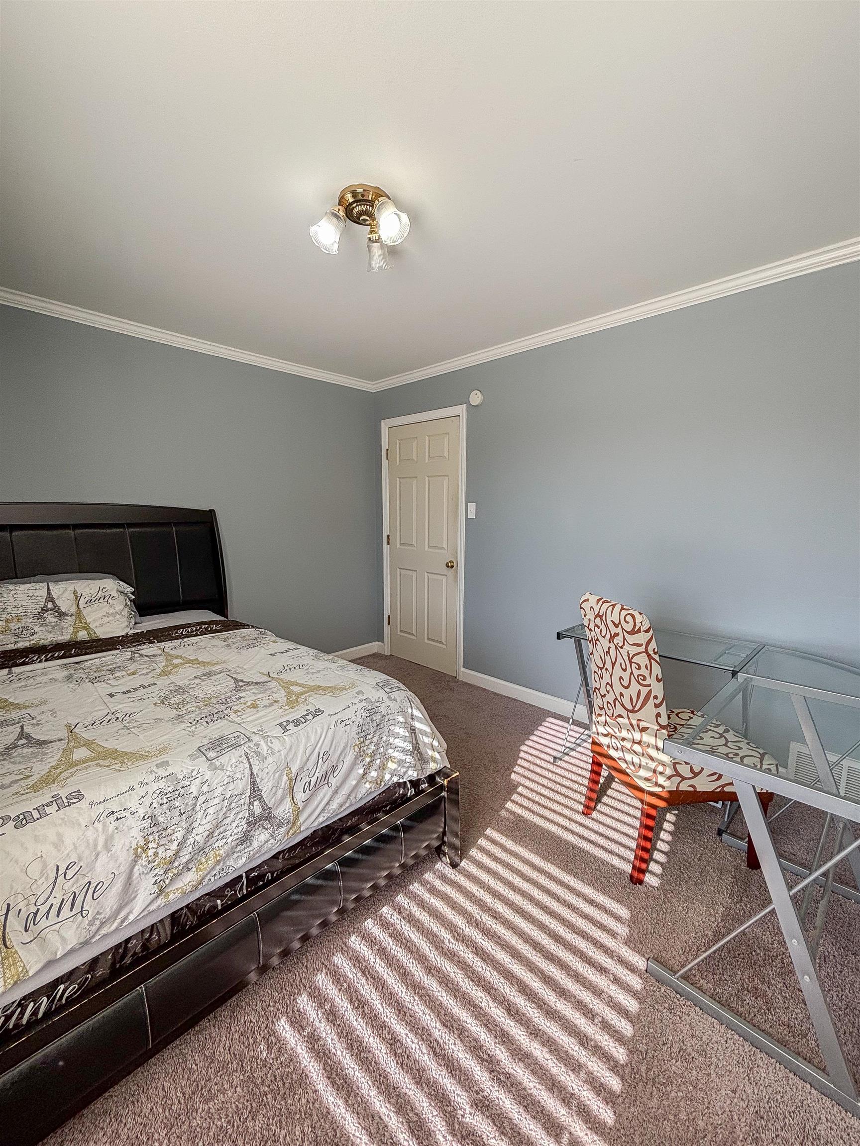 Bedroom featuring carpet flooring and ornamental molding