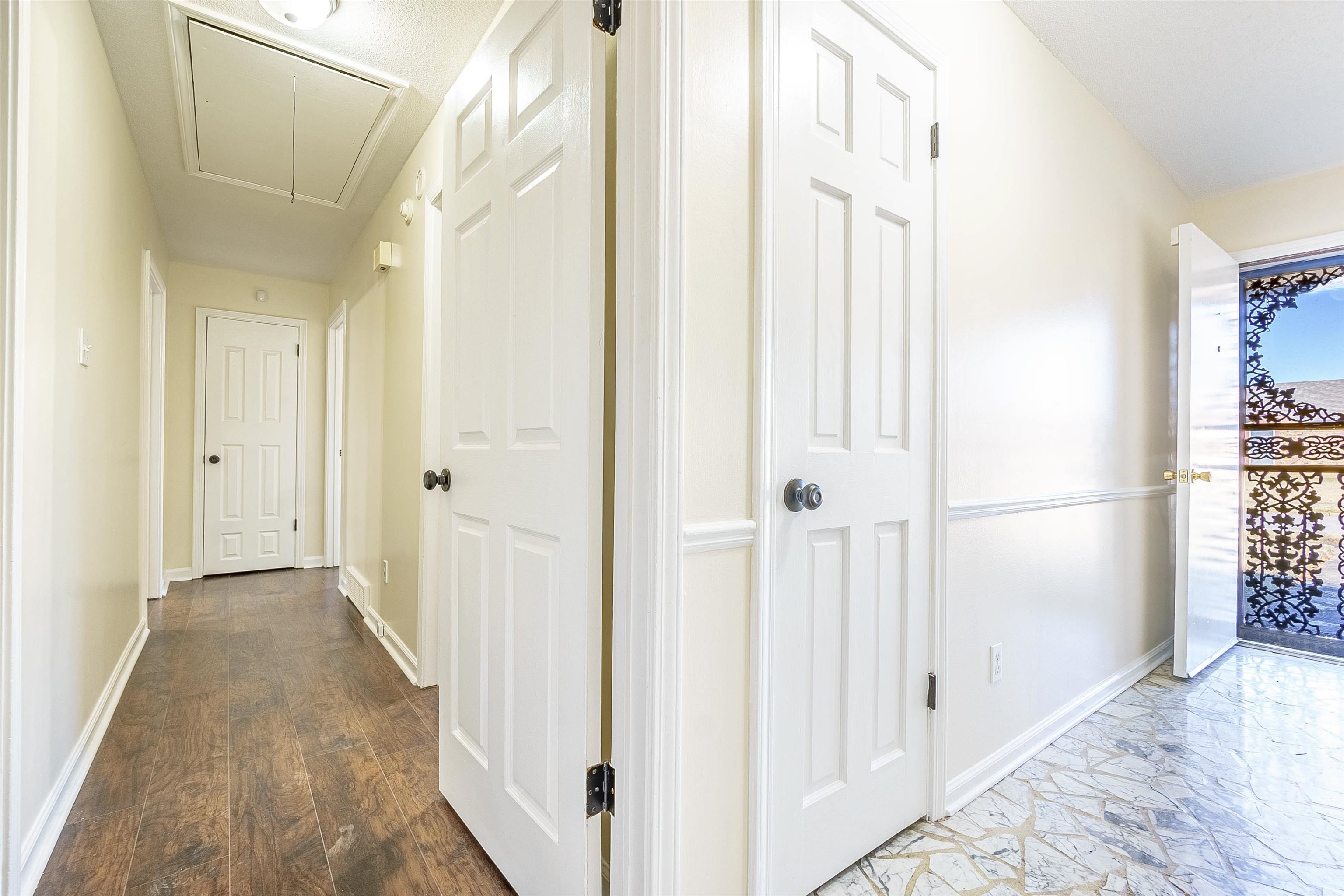 Hall with dark hardwood / wood-style flooring