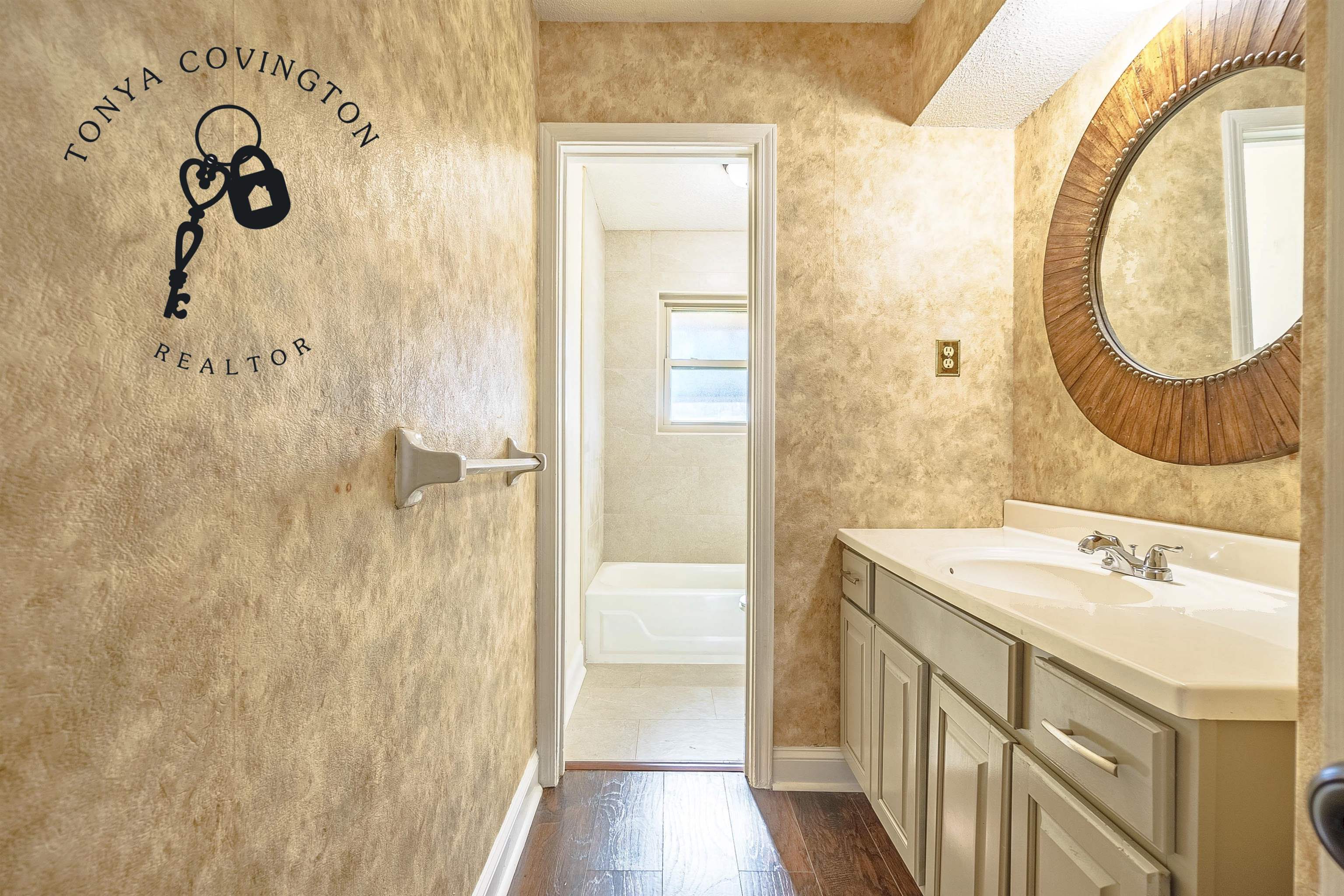 Main Bathroom with a bathtub, hardwood / wood-style floors, and vanity