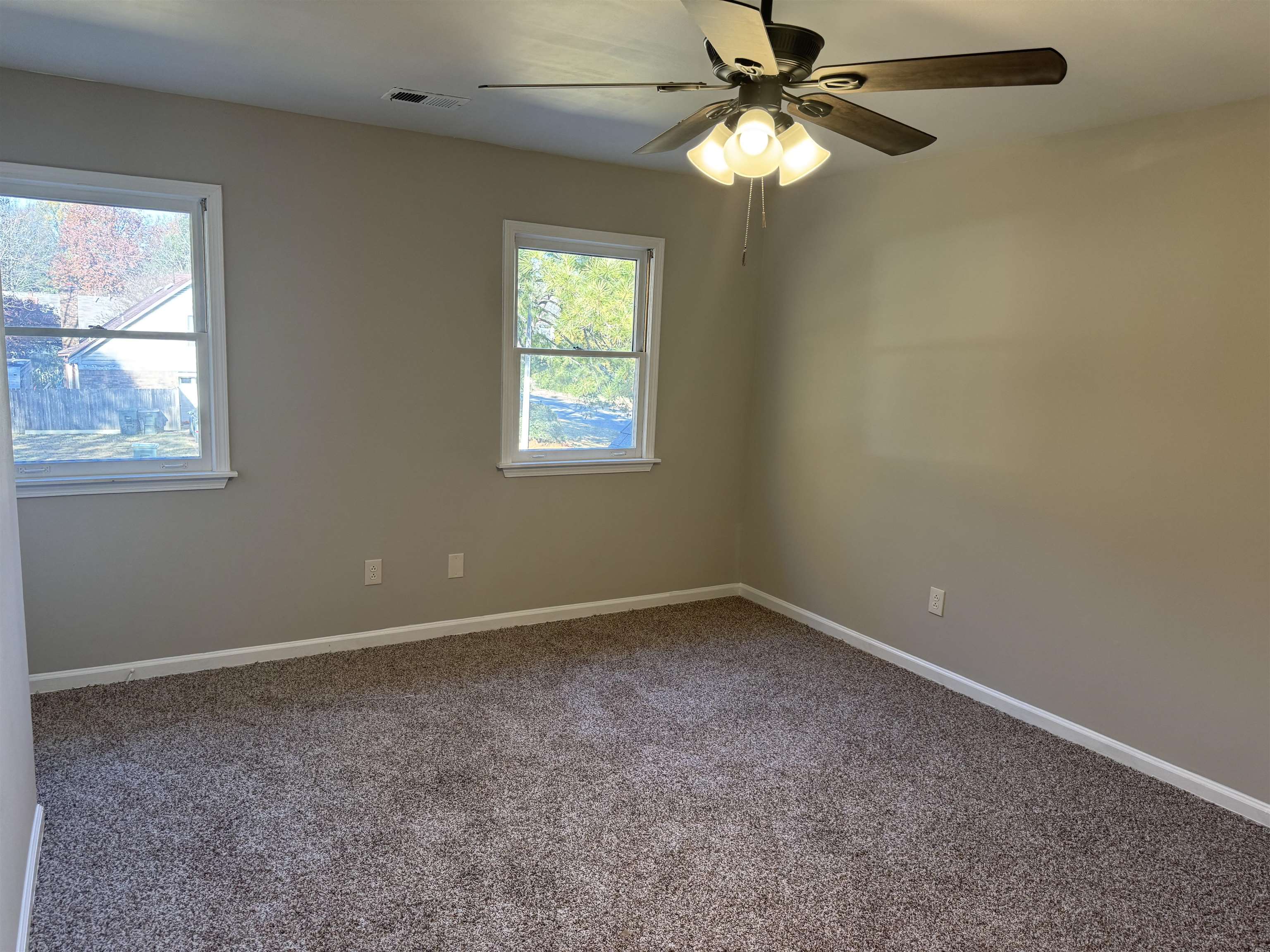 Unfurnished room with carpet floors and ceiling fan