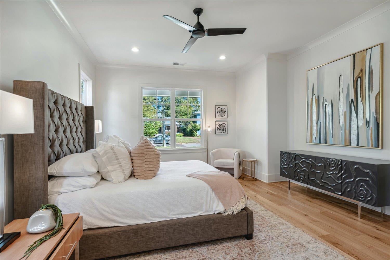 Bedroom with ornamental molding, hardwood / wood-style floors, and ceiling fan