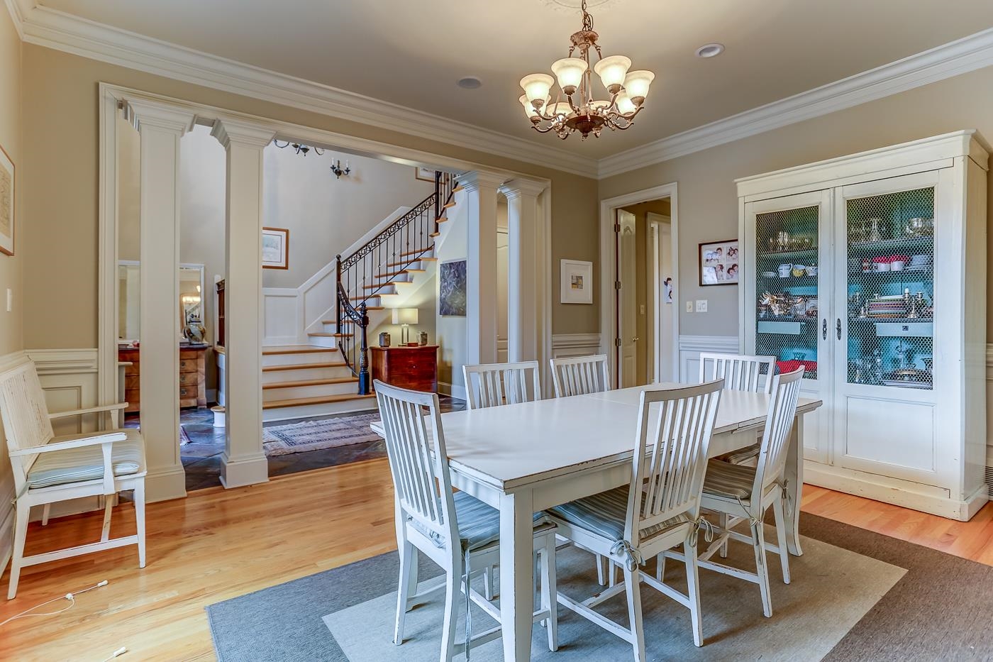 Dining area featuring crown molding, a chandelier, and hardwood / wood-style flooring