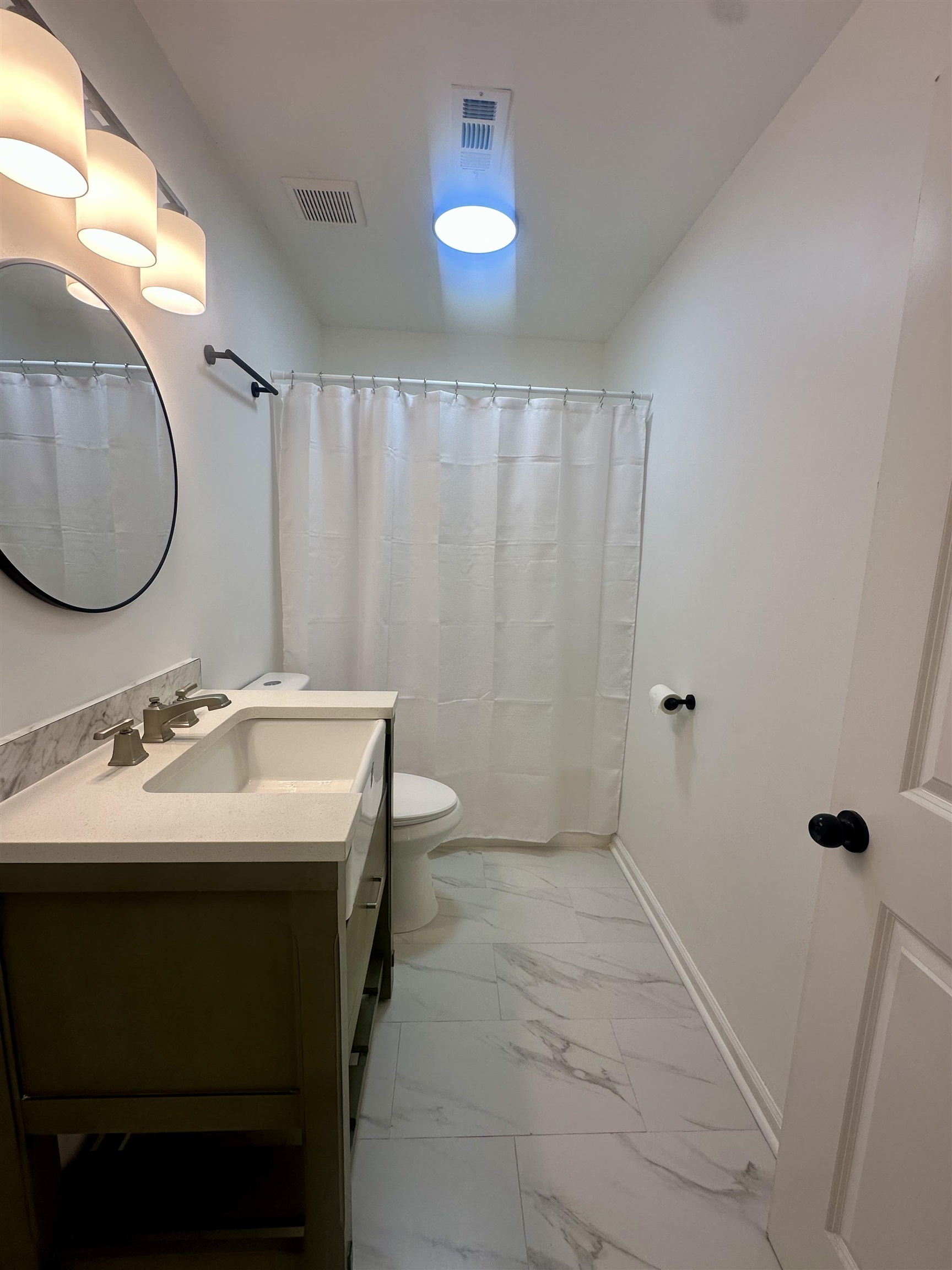 Bathroom with walk in shower, vanity, and toilet