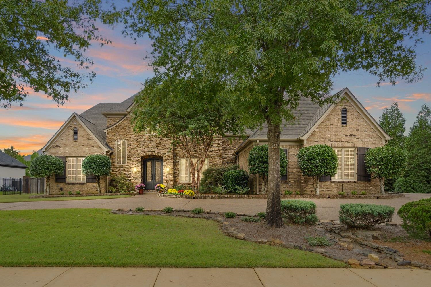 This showstopping, custom built John Worley home is 5 Bedrooms (2 Beds down), 4.5 baths + office, Bonus & Media Room - over 5900 sq/ft! Large lot on almost a 1/2 acre & a 3 car garage! Coveted Braystone Park has a neighborhood soccer field, pool, lakes & wide open green spaces for you to roam & mingle.  Meticulously cared for, Gorgeous nail down hardwood floors, Handmade stone(Cambria)in Kitchen, Custom millwork, Soaring ceilings, Tuscan iron doors, Walk in & permanent attic stairs. Experience outdoor luxury w/ the exquisite Gunite pool, designed for relaxation & entertainment. The pool is perfectly complemented by a cozy wood-burning fireplace, offering warmth & ambiance for cool evenings. Additionally, enjoy gourmet grilling on the built-in Green Egg, ideal for creating unforgettable outdoor dining experiences.  Relax in the 4 season room year-round, this versatile room is perfect for entertaining, relaxing or enjoying the changing scenery.  NEW roof & freshly painted exterior!