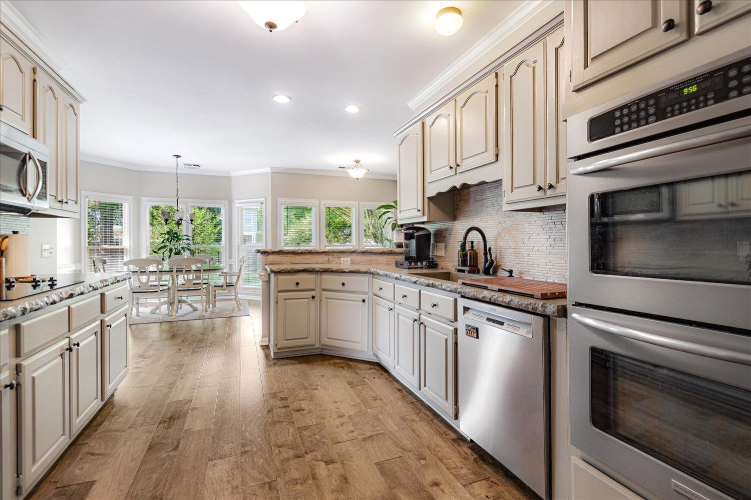 2.25% VA ASSUMABLE LOAN! In the heart of Collierville’s beloved Wellington Farms, this stunning home is the one you’ve been waiting for! Situated on a spacious corner lot, this beautifully maintained home offers 5 generously sized bedrooms (primary suite on the main level) & 3.5 bathrooms, + a large bonus & flex room/office. The open kitchen & keeping room are perfect for entertaining, featuring SS appls, double ovens, a streamlined breakfast bar, & a cozy fireplace in the den. Downstairs showcases hand-scraped hardwood floors, while new carpet adds comfort upstairs. The oversized primary suite includes a sitting area or flex space, a luxurious bath w/ dual vanities, walk-in closet, separate walk-in shower & jetted tub. Roomy laundry w/ sink + 2nd refrigerator space. Enjoy the convenience of a 3-car garage, brand new roof, & HVAC units -1 & 2 yr old, freshly painted, some newly updated windows. Step outside to relax on the back patio in your private backyard—move-in ready!
