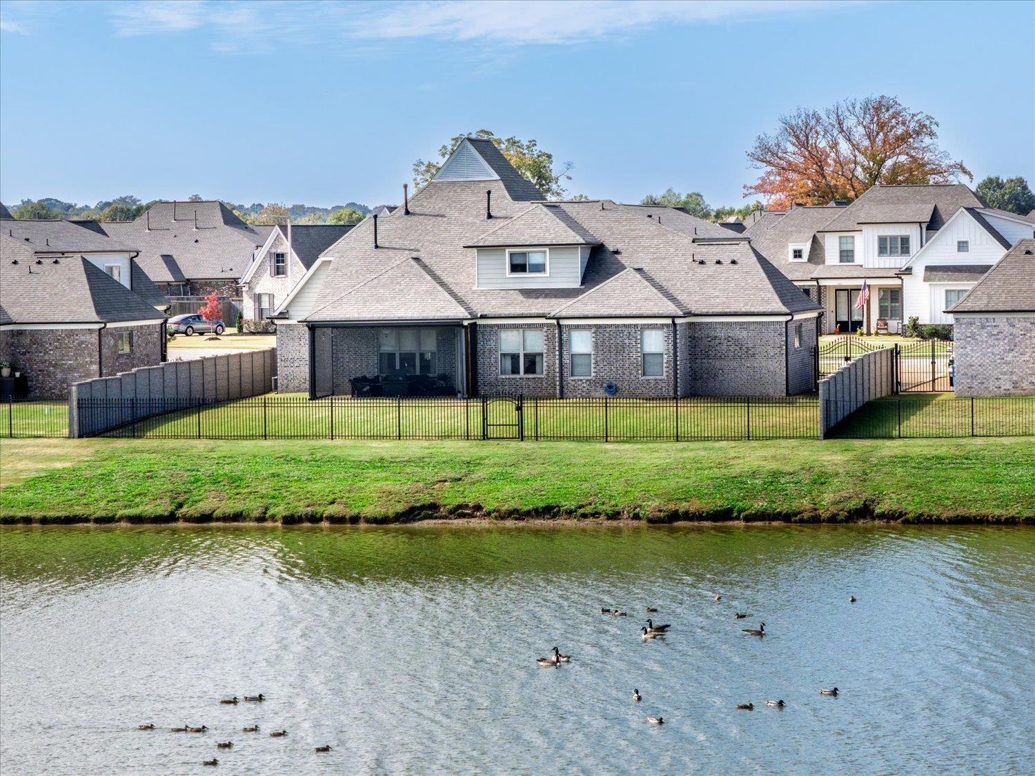 2.75% ASSUMABLE VA LOAN! Beautifully appointed home in the coveted Belmont neighborhood of Arlington! This spacious 5 Bdrm, 3.5 Bth home offers an open-concept floor plan w/ over 3,400+ SF of living space. Owner-added, high-end upgrades completed after closing include: Double Tuscan iron entry doors, Epoxy garage floor, Phantom screen on back patio, Plantation shutters & pull shades, & a Custom wrought-iron/Stone fence. The kitchen is a showstopper w/ a large island, quartz countertops, double ovens, gas cooktop, generous pantry & sunny eat-in area. Additional features include gorgeous hardwood floors, built-in bookcases, mudroom, smooth ceilings, recessed lighting, & a cozy gas fireplace.  Luxurious primary suite offers quartz countertops, dbl vanities, soaking tub, sep shower & two walk-in closets. Enjoy peaceful lake & nature views from the covered back patio. Belmont offers neighborhood walking trails & a pond for evening strolls. Zoned for highly rated Arlington Community Schools.