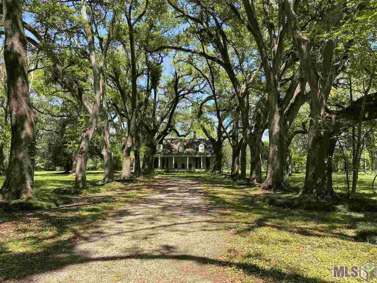 Own a piece of Baton Rouge history on Highland Road just south of LSU! Previously known as “The Oaks,” this 6.18 acre property presents the right buyer with a rare opportunity to acquire acreage with Centennial Oaks along the historic Highland Road corridor, not far from the south gates of LSU.  Gorgeous live oaks shade the driveway leading up to the home which has been owned by the Duplantier family since the early 1800’s. The live oaks provide a beautiful frame for the 4,034 square foot, two-story home, built more than 170 years ago. The elevated front porch has operating shutters separated by three tall windows in the center. Six square columns stand sentinel below three dormers on the roof. Formal dining room. The home’s original woodburning fireplace is below the original brick chimney in the downstairs living room, while the large kitchen had been updated several years ago with a Chambers electric cooktop and double wall ovens. The kitchen also has an abundance of cabinetry, dishwasher and double sink below large windows that view the side yard. The master suite has a walk-in closet and sitting area, while an additional two bedrooms with ceiling fans and a hall bath are located upstairs. The home also has a double garage and an inside laundry room. This is truly a rare opportunity to obtain one of Baton Rouge’s most familiar landmarks on Highland Road. The bonus is six-plus acres along one of the most desirable residential locations in the city. Call today if you’d like to see this amazing, historical Highland Road property!
