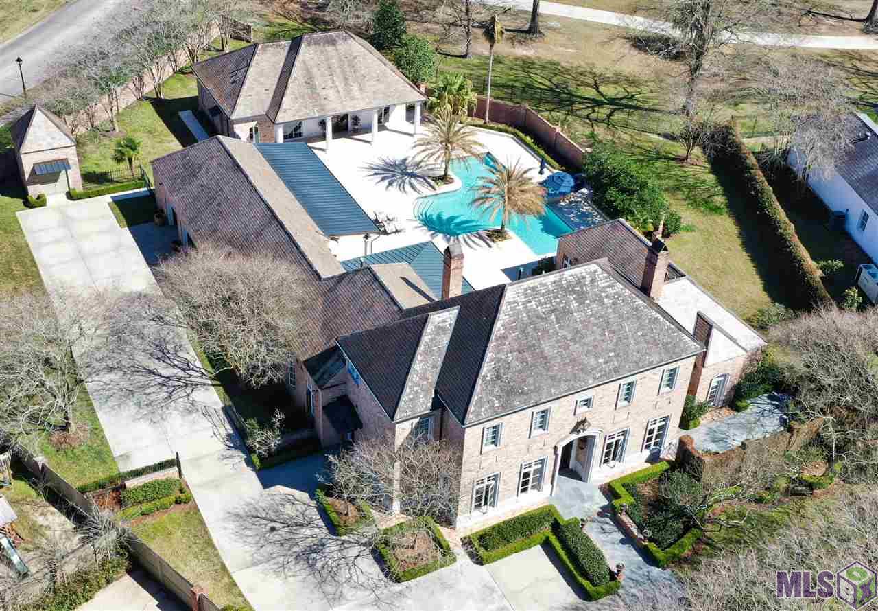 Located in the heart of one of Baton Rouge’s most sought after gated communities, this incredible Estate encapsulates timeless beauty, one of a kind craftsmanship as well as being built with integrity to last a lifetime. No words truly depict the reality of this majestic masterpiece, A MUST SEE TO BELIEVE. Built on over an acre, overlooking Hole #5 of the prestigious CCLA golf course, this one-of-a-kind Jewel leaves nothing to be desired. Jam packed full of priceless features and versatility with 5 bedrooms, 4 and a half baths, 3 laundry rooms, massive bonus room/theatre/home office with all technological abilities imaginable, the master suite on its own wing with private courtyard, cedar plank walled Pigionaire wine cellar, full workshop and the list goes on. Leaving nothing to be desired, the chef’s kitchen is dressed in professional series Viking appliances, brand-new Sub-Zero refrigerator/freezer, beautiful brick floors, cedar plank ceiling, granite counter tops, large island and plenty of storage. Giving the feeling of living your best life or channeling your inner Jimmy Buffet, step out the back door and get swept away by the serene resort like amenities which make every day at home, feel like a vacation. This estate is the true definition of having your cake and eating it too. No expense was spared with this home, plus the newly rebuilt 4,000 square foot sanctuary which includes a New gunite pool and spa with Nature 2 mineral saltwater system, gourmet outdoor kitchen finished with Twin Eagles appliances plus granite counter tops, 2” thick custom cut Ivory travertine stack stone decking, commercial grade drainage, double brick fencing and much more. Finally, the separate 1,550 square foot guest house with open floor plan, full catering kitchen equipped with Viking appliances, massive living room adorned with custom built ins and space galore. Ready to make your Dreams a Reality…. come see for yourself!