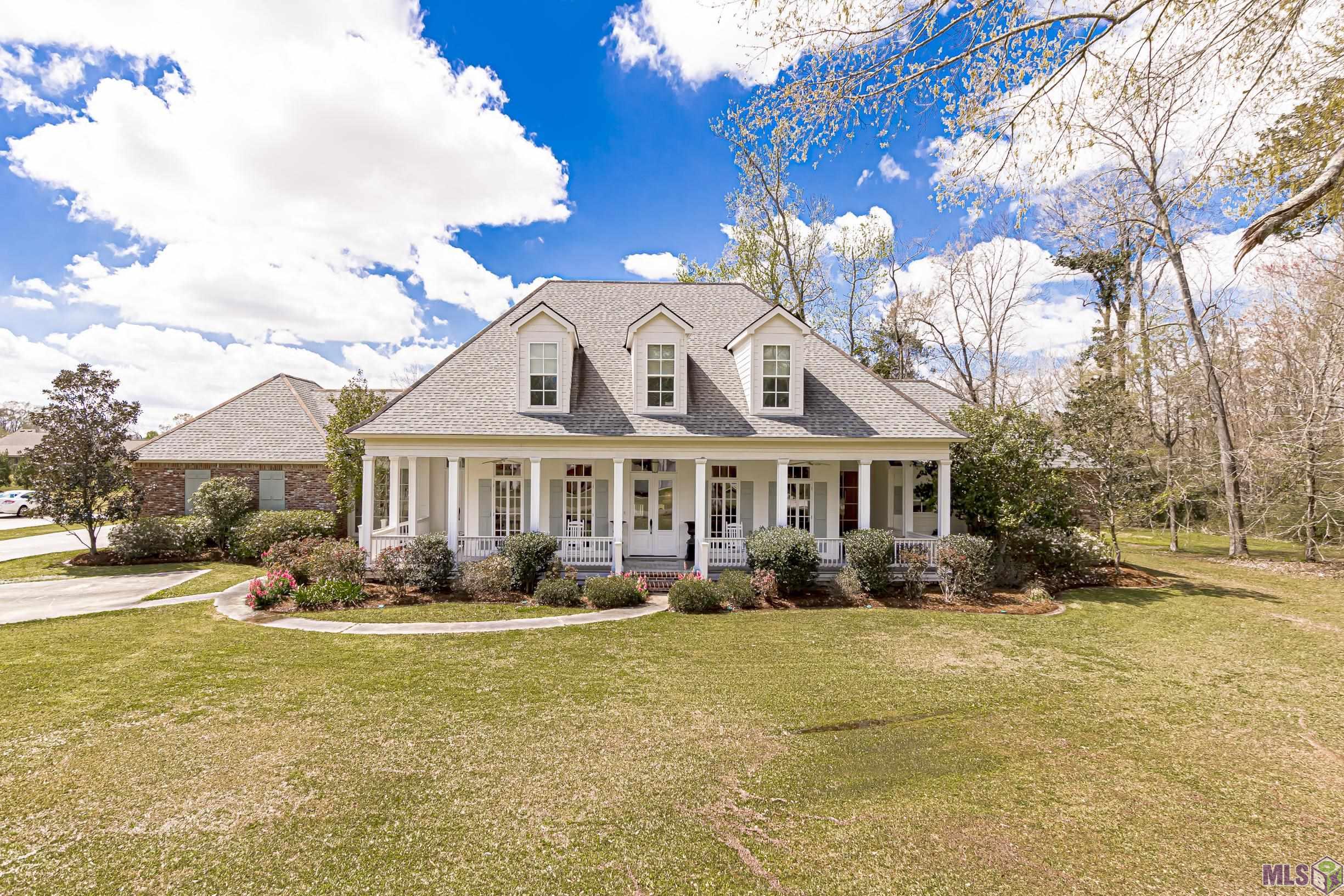 A beautifully built 6000 total square foot 5 bedroom home that sits on over an acre lot! Located in the heart of Prairieville just minutes away from some of the most desired schools and only a few miles from Baton Rouge. This show stopper has it all. Large traditional front porch, presidential office, huge kitchen, mud room, sitting area, and wet bar. This home goes on forever, however its southern charm makes it cozy and a perfect fit for any family. Master bedroom and office are down stairs and remaining bedrooms are upstairs. Custom dirty top pine floors in the main living areas, brick in the kitchen. The custom features of this home can only be truly appreciated in person! Home is not located in a flood zone and HAS NEVER FLOODED Schools include  -Oak Grove Primary  -Prairieville Middle  -Dutchtown High