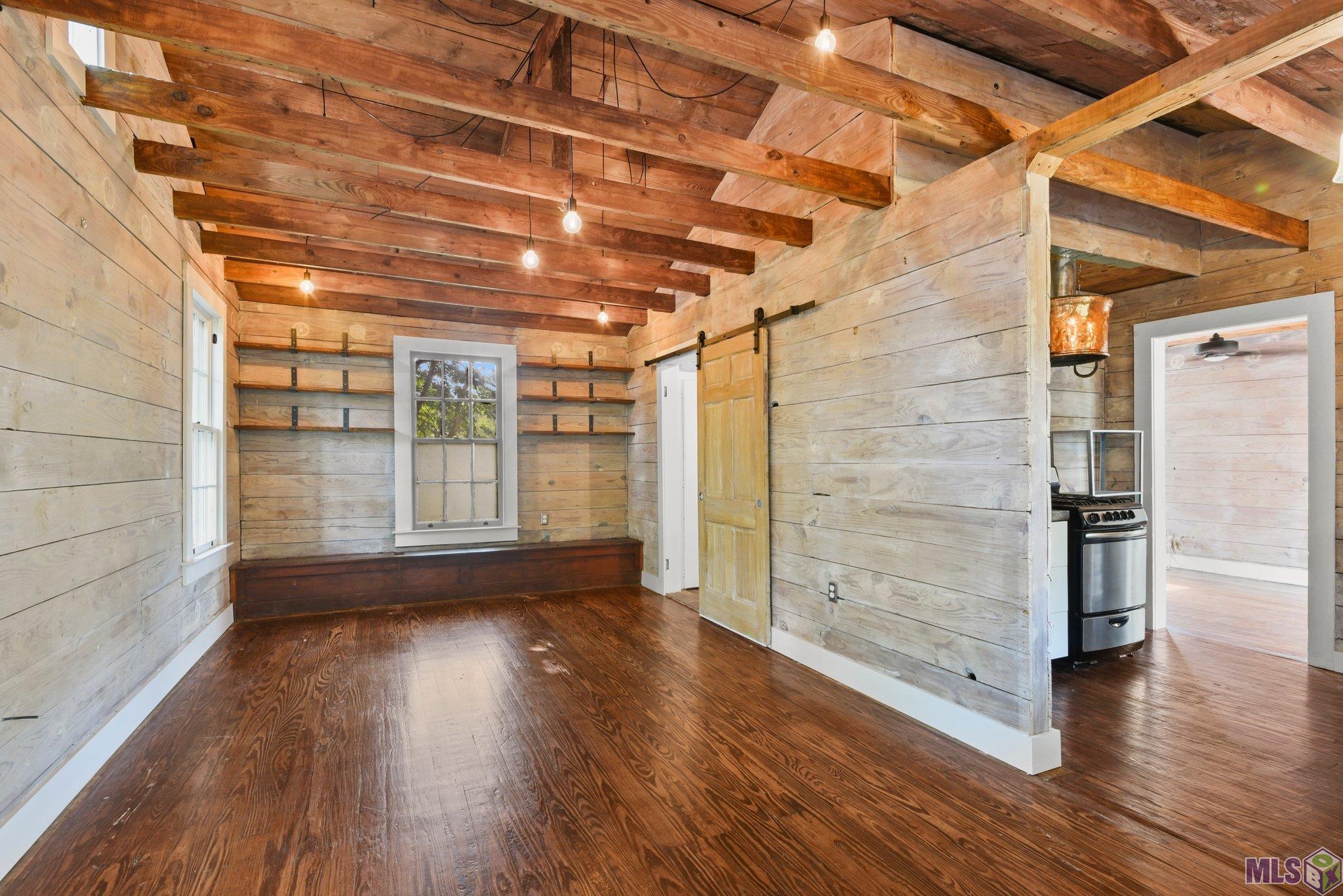 One of a kind private rustic cottage in Capitol Heights. A secluded retreat in the middle of everything midcity has to offer. Redesigned and renovated with all new electrical, updated plumbing, exposed wood walls, vaulted ceiling, wood floors, sinker cypress countertops, cast iron apron front sink, gas range, custom hood vent, sliding barn doors and unique lighting. Fully insulated: closed cell foam subfloor, open cell foam at roofline and cellulose in walls. Living area is on the second floor with washer and dryer at ground level below. Ground floor makes for a great outdoor space that has the potential to be enclosed for additional living space. Property under termite contract. PROPERTY IS NOT ACCESSIBLE FROM HEBERT STREET, must be accessed by way of the alley from Capitol Heights.  Owner/Agent