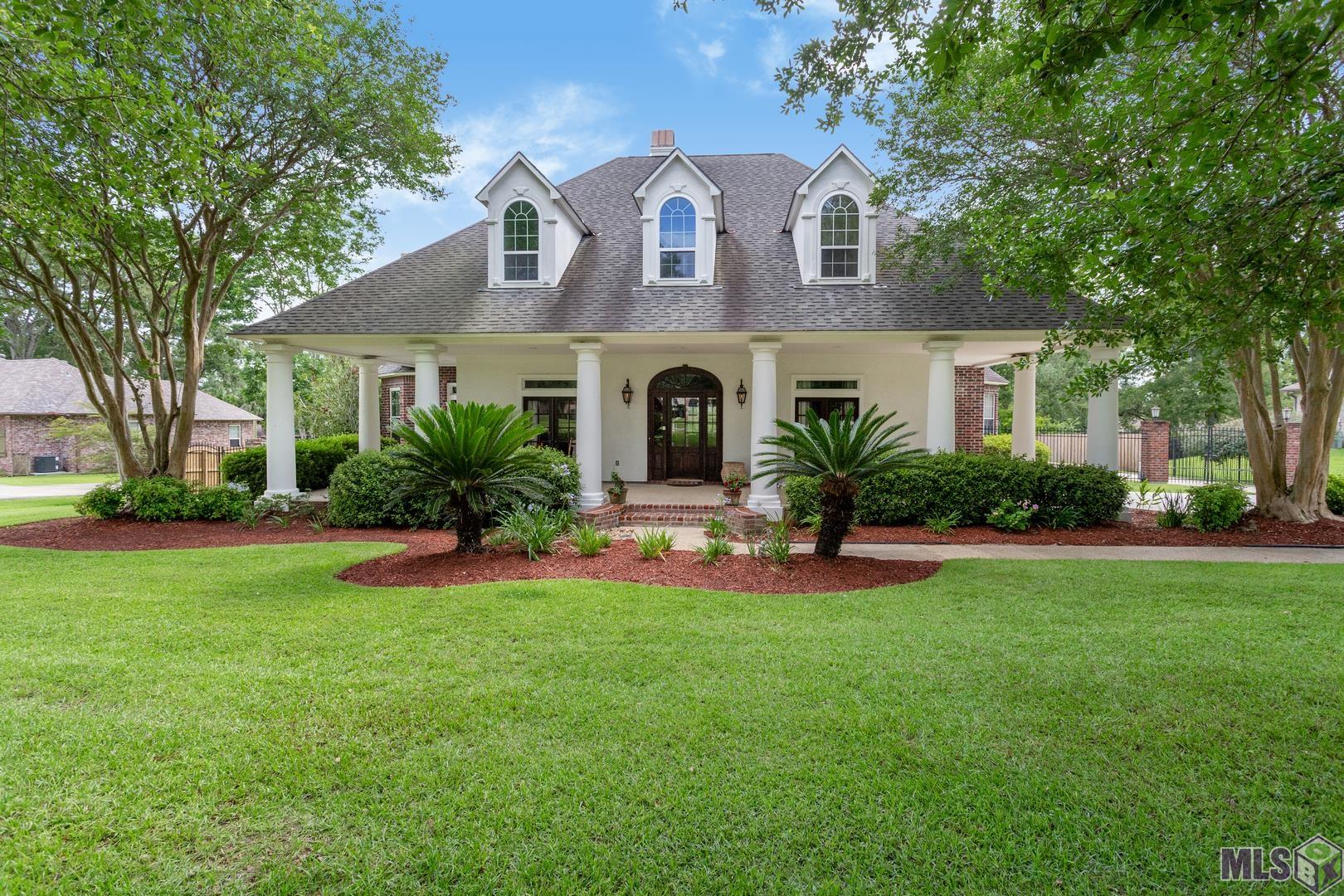 Beautiful 5BR/3.5BA Custom Built Home on a 2 Acre Lot in Highly Desired Manchac Plantation Subd. Features: 3 Car Garage, Outdoor Kit w/Stainless BBQ Pit, Kamado Joe Smoker and Wood Burning FP! Terraced Decking Leads to a Huge Resort Style Gunite Pool w/a Huge Hot Tub w/Rock Waterfall & Slide! Bonus - An 891 SqFt Guest House Located Over the Garage w/Separate Entry Has Kit&Bath (Not Included in Total Living Area).  The 1st Floor Features a Formal Dining Rm, Study, Main Living Area w/FP & Built-ins, Keeping Rm w/Built-ins, Kit w/Granite Countertops, Stainless Appliances, Double Ovens/Gas Cooktop, Island w/Vegetable Sink and Wine Fridge. There is a 1/2BA and Laundry Rm Just Off the Keeping Rm. Spacious MBR w/FP, Brand New Designer Inspired MBA Has Custom Shower, Soaking Tub, and His/Her Vanities. An Added Bonus is the Fabulous New Addition off the MBA w/Views of the Pool Area and Expansive Fenced Yard. This Space Can Be Used as a Nursery, Workout Rm, Office, Prayer Rm or Hobby Rm! Upstairs You Will Find a Large Common Area w/Built-In Entertainment Center/Computer Area, 4 Very Spacious Bedrooms Arranged into 2 Suites on Either Side of the Common Area. Each GBR Has a Private Vanity and Walk-In Closet. Newly Re-Finished Oak Flooring and Brick Flooring Throughout the First Floor of the Main House. Fresh Paint Inside and Out! American Home Shield Home Warranty is Currently in Place and is Transferrable!  Hurry This One Won't Last!