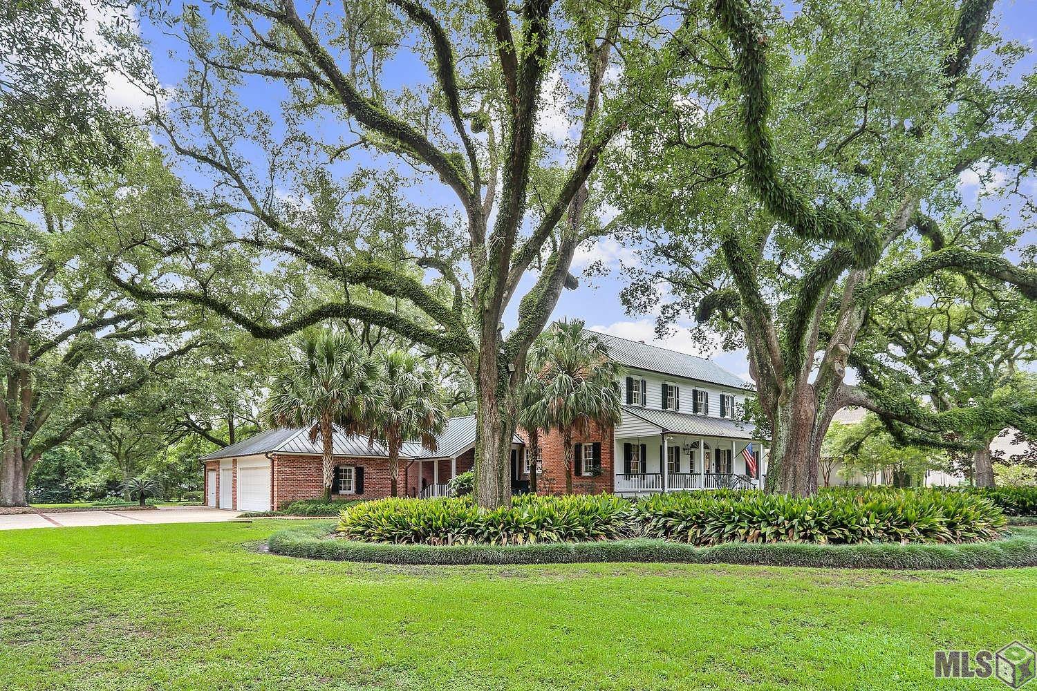 This Al Jones special one-of-a-kind home is sheltered behind majestic oak trees and is located on a prime 1.69 acres. This home exudes elegance and charm! It is rare to find location, a fabulous setting, and the perfect home all in one! Renovations and updating throughout, including a remodel of the kitchen opening up architecturally to accommodate todays living style. This classic home has a lot of space, with a formal dining room, living room, large kitchen/keeping/breakfast, primary suite with two baths, and three bedrooms upstairs. There are beautiful Antique pine floors, Antique New Orleans tan brick floors, and Antique pine beams in the kitchen/keeping area. The extensive “Steel Burden” style landscaping, Pennsylvania blue stone hardscape, a large fountain with a “Pan” statue, an architecturally designed Pavilion built for entertaining and to view the beautiful grounds, copper lighting, and sprinkler system adds to the amazing ambience. To greet your guest there is a brick wall, with six copper lights, at the entrance with guest parking, creating night time drama. The roof, gutters, and lighting are copper. A whole house generator, three car garage, 185 ft asphalt drive parking area, and so much more! Extensive Amenity List, survey, floor plan, and Baton Rouge health district map are available.