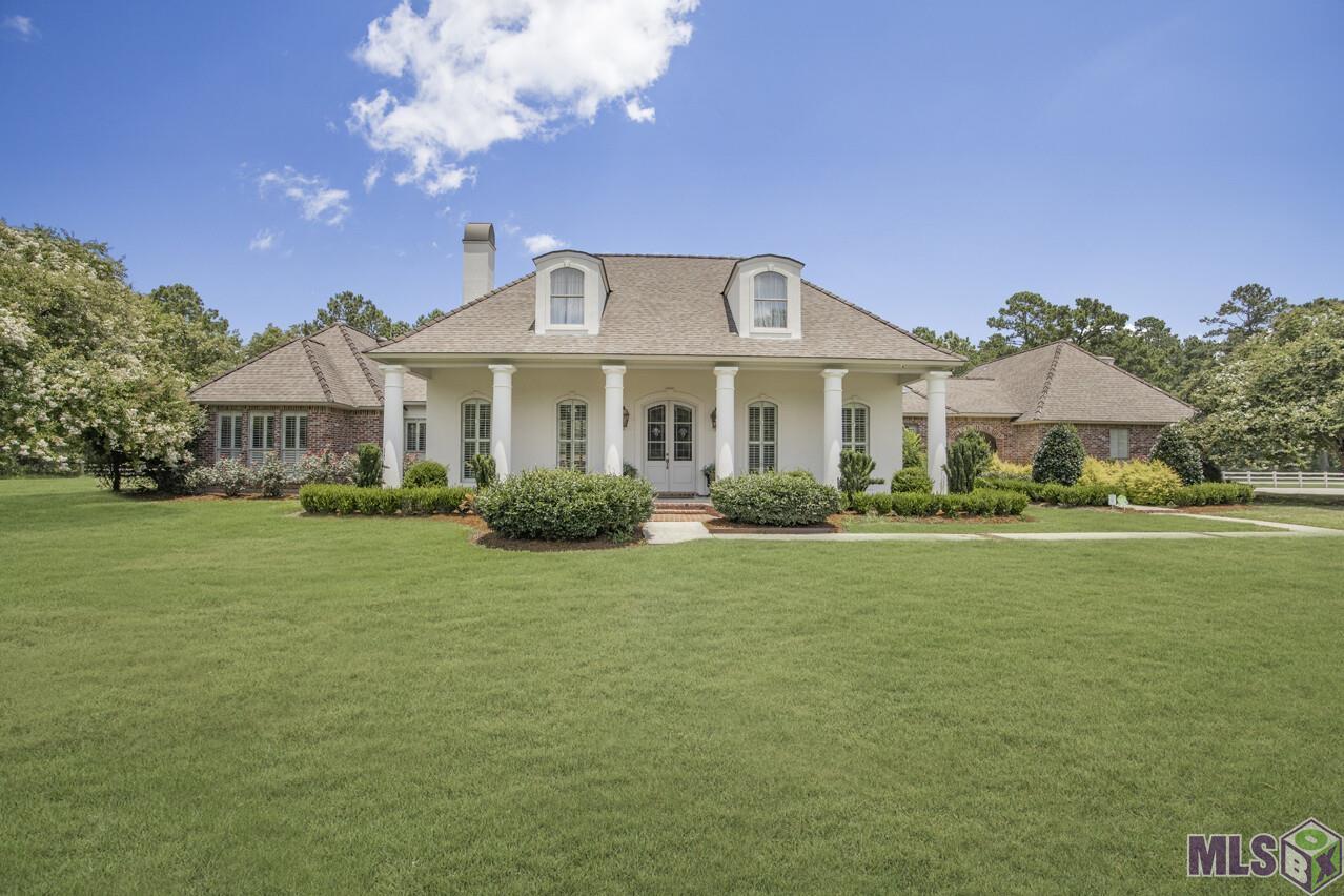 Outstanding classic Louisiana Acadian home custom built by contractor for personal use in 2001.Majestic Oaks at gated entry lead to an oversized front porch with large columns.There is a parking area for guest that leads to a side entrance with wrought iron gate. Interior and exterior fresh paint. Entering the home, the foyer opens to living room on one side and opposite is formal dining room all featuring heart of pine flooring!! New plantation shutters throughout the home with some custom draperies allow an abundance of natural light! Updated designer lighting provides a new feel to the residence.The gourmet kitchen has built in Thermador refrigerator, 6-burner double oven.All new soft close cabinetry with 7' hood over cooktop and 10 ft island. Monte Blanc quartzite countertops are outstanding! True brick flooring runs throughout this area and into hallway. The keeping room on the other side of kitchen/island has a fireplace and additional built-in cabinetry. This space could also serve as a breakfast area if desired. Office has built-in desk and heart of pine floors.The master bedroom is just beyond the office which creates a very private suite.There is a large bank of windows on the front facing wall of oversized master bedroom.Master bath has jetted tub with oversized shower and wonderful California closet!!The bedrooms at the far end of the home near the garage are nice sized with Hollywood bath and more closet storage.The triple garage has a bonus room above with a bedroom, sitting area and full bath.The floor in triple garage has the non-stick epoxy coating.The pool house has new paint and perfect for entertaining around the Grecian gunite pool with 3 fountains and new cool deck surfacing.This area also provides a lovely view from the living room.There is a second concrete driveway leading to a 40x60 workshop with 15ft. rollup door. Bonus room living area of 300 sq ft and pool house living area of 375 sq ft are not included in total living area.
