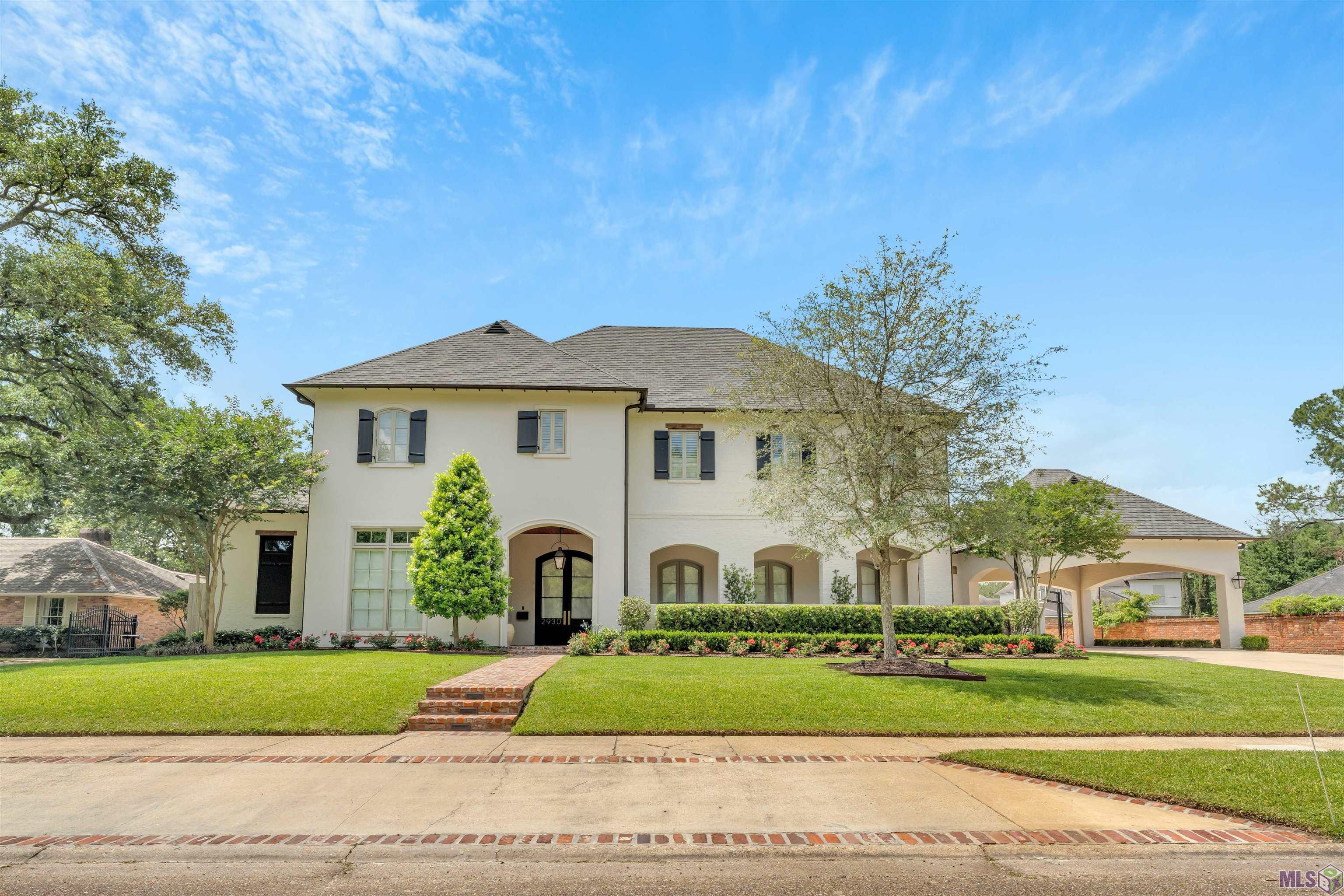 This beautiful home in Jefferson Place/Bocage Subdivision consists of 6 bedrooms/5.5 baths, with an additional 2,815 sf of outdoor covered space. The front showcases arches with an oversized breezeway/courtyard with seating area. The contemporary home as you enter shows the open modern floorplan into the living, kitchen and breakfast area. The spacious kitchen highlights SubZero appliances, 60" French range, wine/coffee bar space, custom cabinetry, marble countertops, and brass/copper/lucite hardware throughout. The main floor provides an add'l bedroom for guests and a stylish bathroom/shower. This home features a formal dining room/pool table/game area, and a formal office space that has access from the primary bedroom. The primary closet also provides a desk workspace/vanity area, located alongside the primary bathroom. As you enter the upstairs level, it features a media room and 3 roomy bedrooms with 2 baths surrounding a children's entertainment/bunk area for added privacy.  The spacious outdoor living area has retractable remote shades and a double-sided Isokern fireplace. The outdoor kitchen offers a Lynx grill/griddle top, commercial vent hood, an under-counter refrigerator, and a large island/sink-prep area. The oversized backyard has a 50' pool with a tanning ledge, deck jets, bubblers, remote LED lighting, and an open green space for kids. This well-thought-out home also contains an air-conditioned fitness room overlooking the pool, with pool bath nearby. The add'l private living area provides another bedroom and bathroom allowing for a multi-use space, which can be curated as a guest quarters for family/friends, gameroom/entertainment area, or a yoga room. Added features include a surround sound system inside and outside the home, a porte-cochere that spaciously accommodates two vehicles and side parking, a two-car garage, and a 1/2 basketball court, with add'l parking spaces in front, and a 40 KW Katolight commercial generator for uninterrupted power.