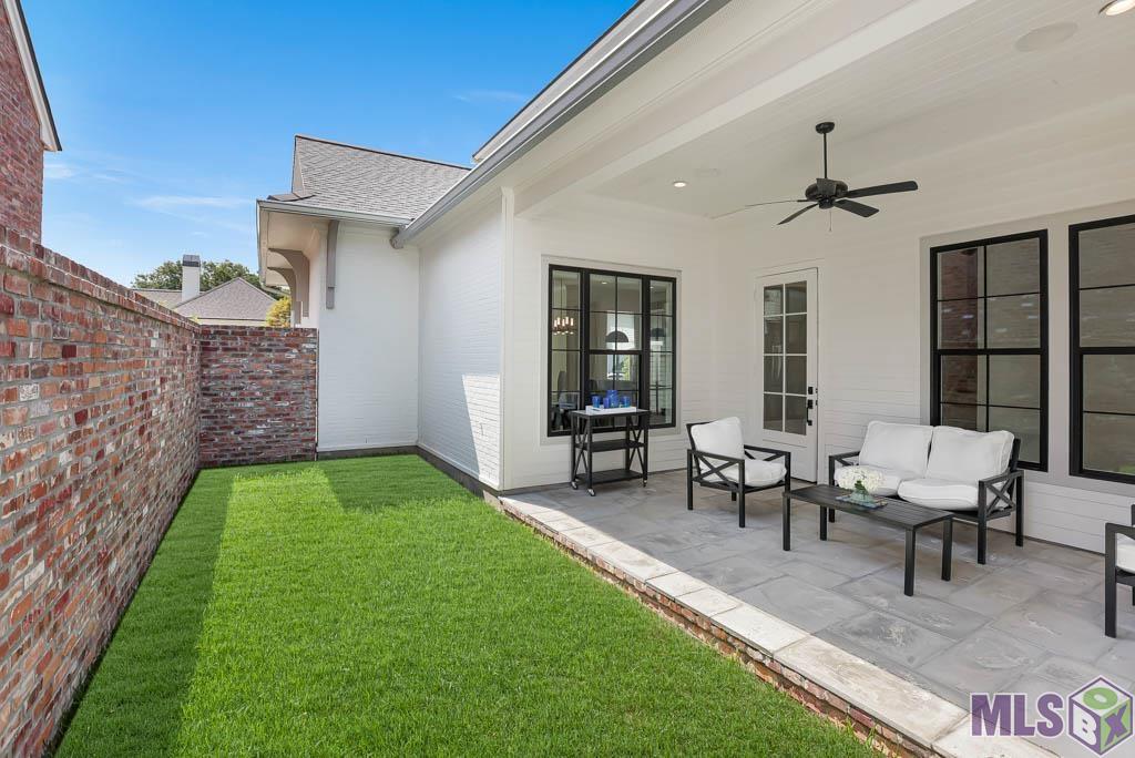 The side porch is the perfect place to unwind and serves as an additional space to entertain with such easy access off the kitchen, dining and living room.
