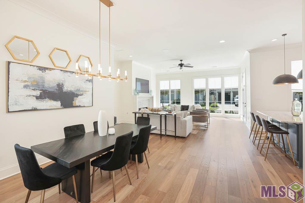 The beautiful lighting fixture anchors this space perfectly.  The dining room sits six or more with room to spare and would accommodate a round table with ease.