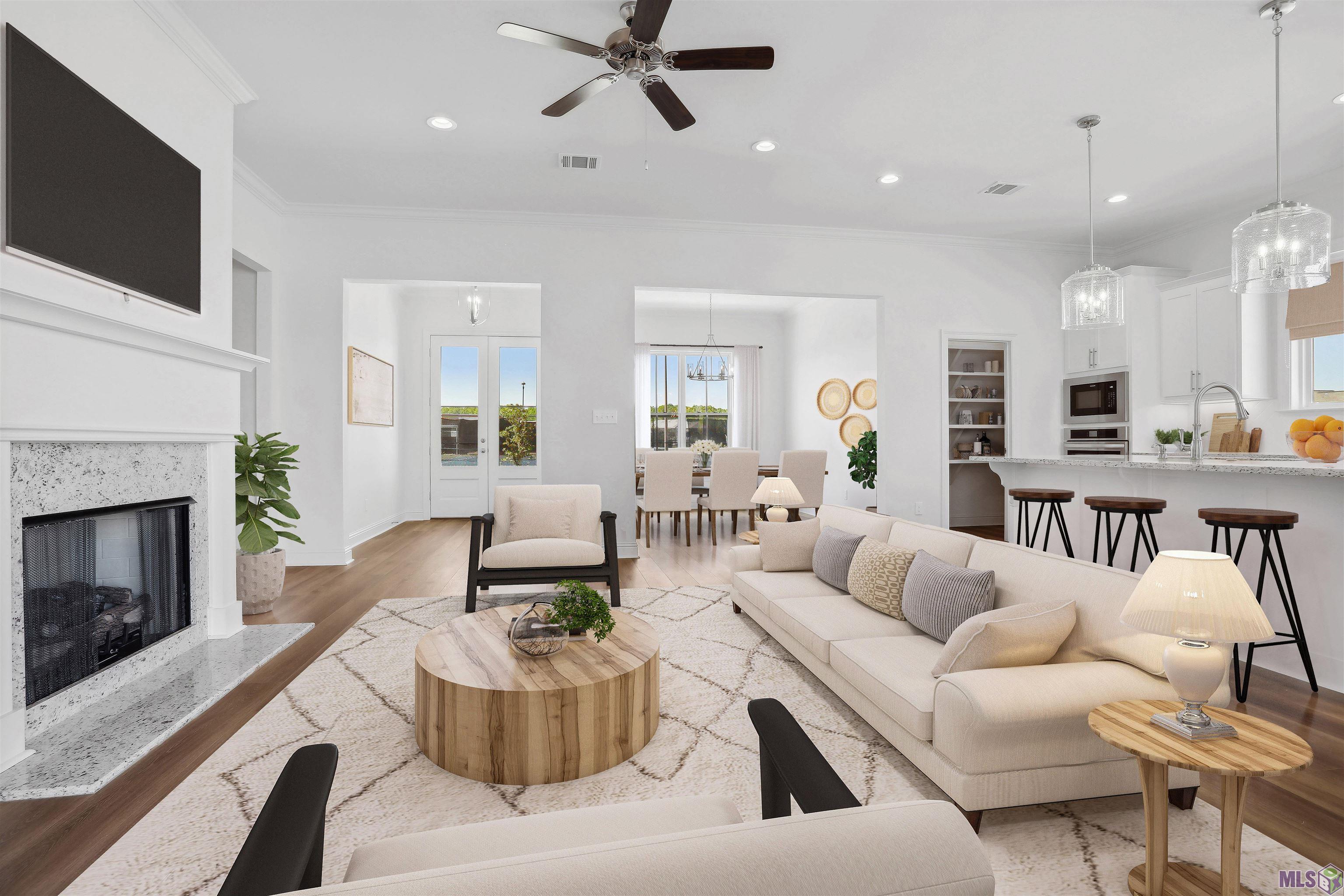 Brand new floor plan in Americana, Zachary’s only Traditional neighborhood development. The Lincoln is a one-story home that is over 1900 sq feet and features a true foyer which opens into the spacious living room.  The living room is centered around a ventless gas fireplace with wood trim casing, granite surround and milled mantle and has French doors that open to the large covered rear porch!  The gourmet kitchen is open to the living room and has custom painted cabinets with under cabinet lighting and 5" hardware pulls, large center island with sink and hanging pendants, granite countertops and a 3x6 ice Bright White subway tile backsplash, stainless appliance package including a gas cooktop and walk in pantry!  The dining area is separate from the kitchen with a large window overlooking the street scape with tons of natural light. This is a split floor plan with the master suite located off of the rear of the home.  The large master has a spa like bath with a soaking tub, custom tiled shower with a seamless glass enclosure, dual sinks and LARGE walk in closet.  Bedrooms two and three are spacious in size and share a hall bath.  The laundry room is spacious with an area for an extra fridge or shelving and there is a linen closet located off of the laundry room – tons of storage! HOME IS MOVE IN READY!!  Americana has amenities such as the YMCA with an Olympic length swimming pool, tennis courts and a community dog park, pond, playground and dining within walking distance from your front door!   Model home open weekly, other lots/plans available.
