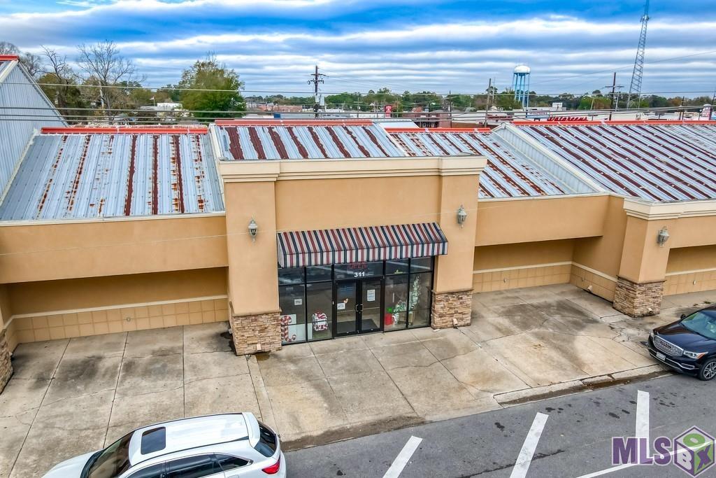 Seven buildings situated on 1.66 acres at the intersection of S Range Avenue and Florida Blvd, in the Heart of Denham Springs. Building 1 is approximately 12,300 sq ft of retail space and building 2 is approximately 2800 sq ft of retail spaces. Building 3 through 7 range from 975 sq ft to 3840 sq ft of warehouse/storage buildings and typically lease for warehouse/storage type use. Building 1 is occupied by a large retail business which will be relocating upon sale of property and building 2 is leased to a retail business which shall remain in place. *Structure square footage nor lot dimensions warranted by Realtor.