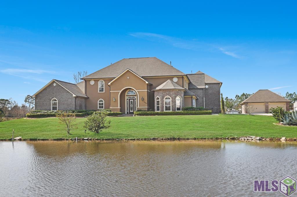 This home has 5 bedroom 4.5 bath, office, multiple bonus rooms and a media room making it a rare find in Ascension Parish.  Don't miss out on this amazing home that checks all the boxes you have been dreaming about.  Driving up to the property you will notice this luxury home sitting on 2.28 acres, with a large pond in the front yard, long driveway and 4 CAR GARAGE!  This home has recently been upgraded with all new interior paint including walls, trim and cabinets.  The seller also upgraded the backsplash and much of the lighting. Entering the home you will step into a beautiful foyer and your eyes will be drawn to the stunning iron staircase and the 20 foot ceilings.  You will love the new light fixtures, large windows letting in tons of natural light, and the fireplace with built-ins around it.  The kitchen has granite countertops, stainless steel appliances, large island and an additional bar space to gather around and share a meal.  The master bedroom is huge and has a nice size sitting area overlooking the backyard, a fireplace and more built-ins The master bedroom also includes 2 massive walk-in closets that you would have a hard time filling up.  The master bath is also large with double vanities, oversize tile shower with multiple shower heads, soaking tub and water closet.  Upstairs you have several bedrooms, a nice landing area, a flex room that could be used for exercise equipment or many other things.  Additionally there is a full media room with a small kitchen area for you to enjoy movies and gaming with friends and family. All ac units have been replaced in the last 5 years and the home has been wired and has the switch installed for a generator.  This home is in flood zone x and has never had any issues with flooding.  Currently priced significantly below recent appraisal. Make your appointment today!