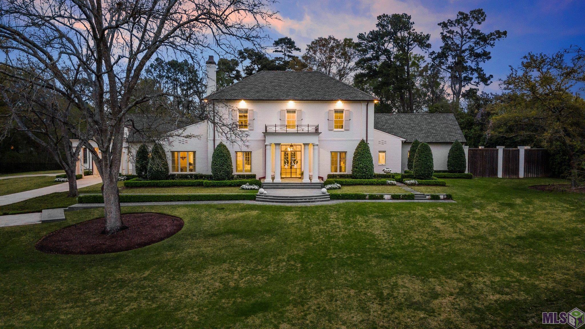 One of Baton Rouge’s most luxurious and stunning estates that was custom built in 2018. This home sits on 1.75 rolling acres in the middle of town in the highly sought after Southdowns/ Meadow Lea area and graced the cover of Traditional Home magazine in 2023. No expense was spared building this one of a kind beautiful home, designed by Hoffpauir Studio Architects, built by Bernhard Normand Construction and decorated by Colleen Waguespack of CW Interiors. Custom made steel and glass front doors from Chateau Dominque in Houston, TX welcomes guests to take in every exquisite detail inside. 4 bedrooms, 5 ½ bathrooms. Large foyer with custom iron curved staircase, formal living room, formal dining room, wine room/gentleman’s library or study with climate control steel and glass wine storage unit, stunning long gallery/hall with exposed natural beams, breakfast area, and den/keeping room, . Large kitchen with custom finishes, butler's pantry and top of the line appliances. A unique side sunroom welcomes guests off the porte cochere, office and maildrop area off sunroom, full workout/gym area above garage with full bath and steam shower. Huge master suite with floor to ceiling marble in master bathroom and custom designed master closet. Second floor features 2 BRs, 2 full BAs, w/ a childrens' den/study hall area. Some features include rift cut white oak flooring throughout, Bevelo gas lanterns, 3 car garage,  3 tankless hot water heaters, exterior custom European style landscaping and lighting, 16 zoned irrigation system, Control 4 Smart Home Automation system, built in outdoor kitchen with custom brick pizza oven, heated pool and spa by Russell Pools with expansive bluestone patio and decking, large gas firepit area by pool, huge loggia offering living and dining space, 3 gas fireplaces, mudroom off garage with custom shelving, large three car garage and whole home generator. It’s all in the details. Truly a once in a lifetime opportunity.