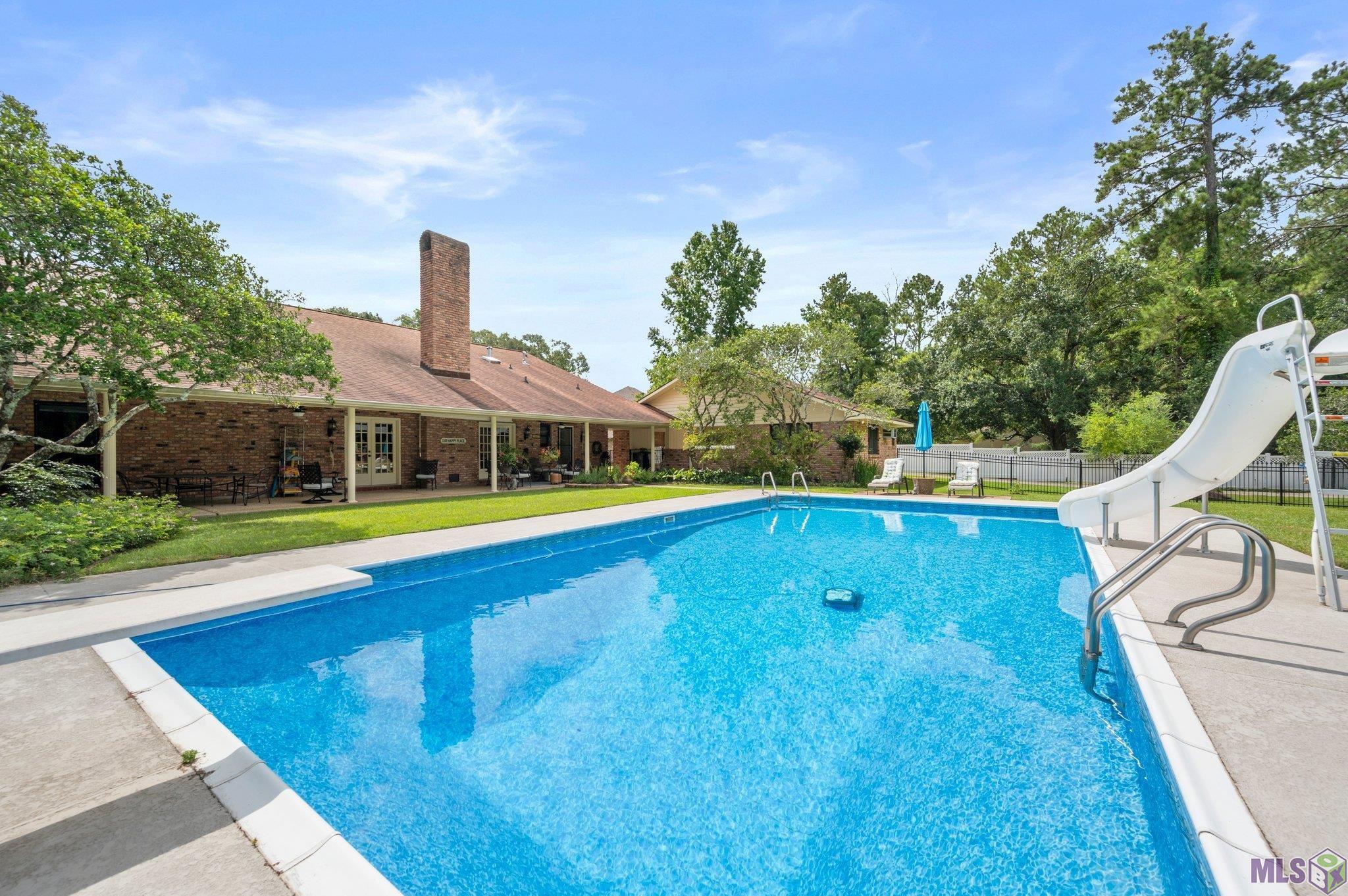 Welcome Home &  Just in Time for Summer! This Turn Key Main home includes 4 bedroom, 3.5 baths. The  pool house is not attached to main home and includes another full bath. Making total living area 4062. All this sitting on 3 acres of beautiful property in sought out  Comite Hils Neighborhood.  Kitchen has Quartz counters and Marble in bath. Appliances 4 years old. Pool with new liner. Whole House Generator, New Hvac, Picturesque Barn w/large workshop and storage areas.  All of the rooms are large with beautiful views.  Beautiful Pella Windows come with lifetime warranty. Move in ready, "really"!  Has never flooded and is in Zone X.  Seller offering Home Warranty.  Bar in Den & Island in Kitchen are not attached to the floor and can easily be removed.  Golf Cart & Zero turn radius mower are negotiable with sale. Schools, shopping & restaurants nearby.