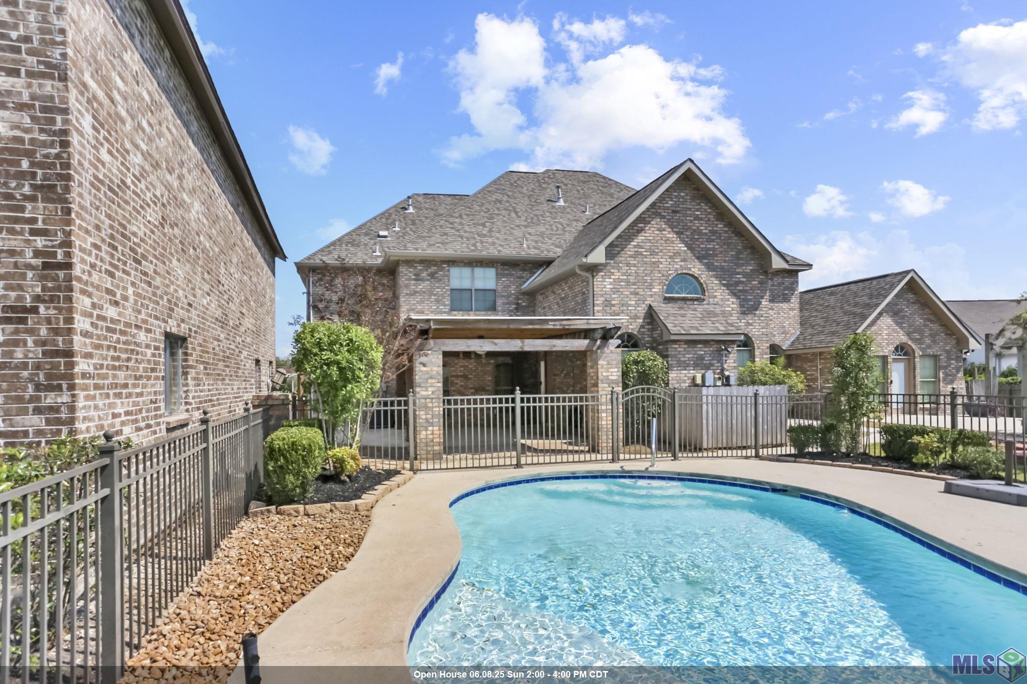 MOTIVATED SELLER!!! Welcome to your dream retreat in Gonzales, Louisiana! This stunning home in beautiful Ascension Parish boasts approximately 5,000 sq. ft. of living space on a spacious lot of about an ACRE. Conveniently located just 35 minutes from New Orleans and 30 minutes from Baton Rouge, and it is near the interstate plus the Gonzales airport! Enjoy a dedicated MOVIE ROOM plus a large loft area ideal for a GAMEROOM or pool table. Office could be a 5th bedroom! Relax by the SWIMMING POOL and entertain under one of two pergolas, and take advantage of the impressive boat port—perfect for an RV, a MOTORHOME or a large BOAT.  Or even use the separate building for a workshop!  The interior of the home has been freshly painted and it is light and bright.  The home is clean and ready to be moved in to.  Be sure to notice the oversized primary suite that is located on the first floor and the impressive fireplace in the living room.  This two story home is high and dry and has never flooded and it is equipped with a whole home GENERATOR.  Additional amenities include a 3 car garage and proximity to top rated schools.  This property is a must see for anyone seeking lifestyle without sacrificing convenience.  The beautiful Loosemore area is full of greenery and pretty trees and landscaping and near Tanger Mall and lots of great restaurants too!  Schedule your showing today!