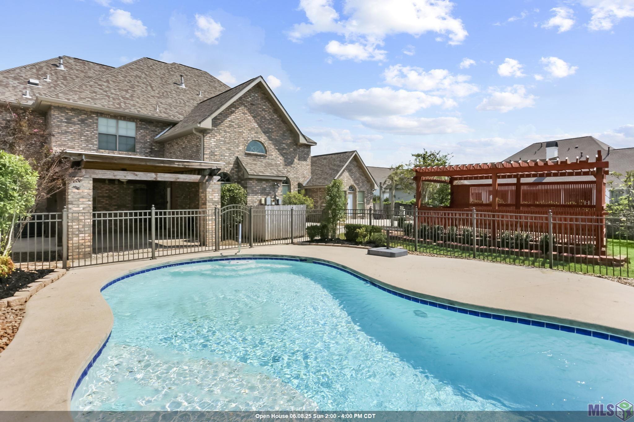 MOTIVATED SELLER!!! Welcome to your dream retreat in Gonzales, Louisiana! This stunning home in beautiful Ascension Parish boasts approximately 5,000 sq. ft. of living space on a spacious lot of about an ACRE. Conveniently located just 35 minutes from New Orleans and 30 minutes from Baton Rouge, and it is near the interstate plus the Gonzales airport! Enjoy a dedicated MOVIE ROOM plus a large loft area ideal for a GAMEROOM or pool table. Office could be a 5th bedroom! Relax by the SWIMMING POOL and entertain under one of two pergolas, and take advantage of the impressive boat port—perfect for an RV, a MOTORHOME or a large BOAT.  Or even use the separate building for a workshop!  The interior of the home has been freshly painted and it is light and bright.  The home is clean and ready to be moved in to.  Be sure to notice the oversized primary suite that is located on the first floor and the impressive fireplace in the living room.  This two story home is high and dry and has never flooded and it is equipped with a whole home GENERATOR.  Additional amenities include a 3 car garage and proximity to top rated schools.  This property is a must see for anyone seeking lifestyle without sacrificing convenience.  The beautiful Loosemore area is full of greenery and pretty trees and landscaping and near Tanger Mall and lots of great restaurants too!  Schedule your showing today!