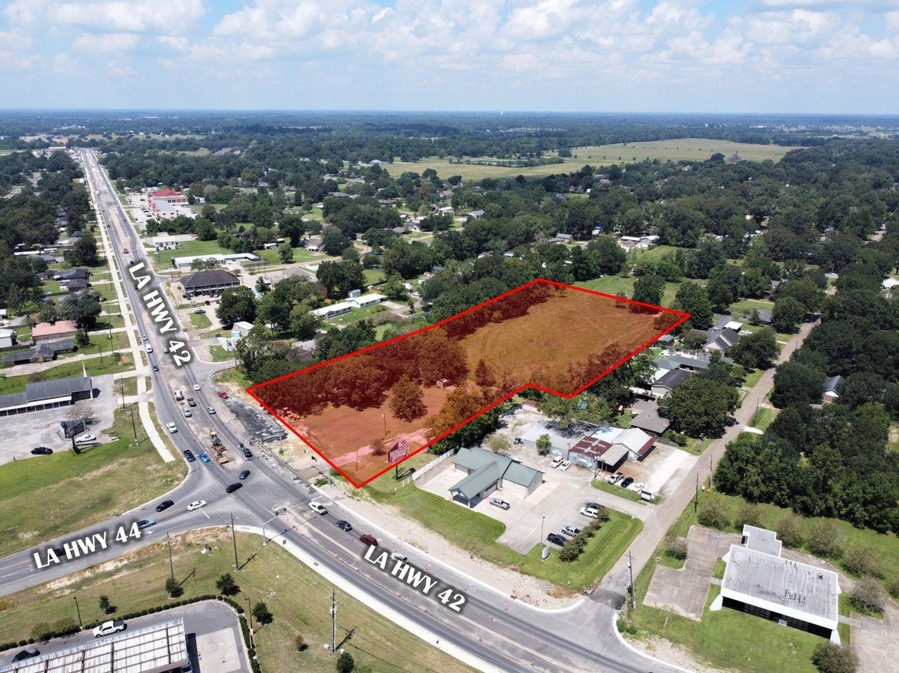 40512 LA-42 features 4.26 acres of majorly cleared vacant land. Located on the lighted hard corner of LA Hwy 44 and LA Hwy 42 in the growing Prairieville market. This location is ideal for both single family and multifamily developments. Surrounded by multifamily and commercial developments such as Walmart Neighborhood Market, Dollar General, and Sonic. Located in an area with strong average household income and a high traffic area with over 27,000 vehicles that pass this site per day. The Mixed Use (MU2) zoning district is characterized by the most intensive residential and commercial development. These districts are in areas where the road system is most capable of supporting growth.  • Prairieville Vacant Land For Sale  • Located at the Intersection of Hwy 42 & Hwy 44  • Directly Across The Street From Walmart  • Ideal Location For Both Single & Multifamily Developments  • House On Property Is Currently Leased  • Located On The "Main Artery" Of Ascension Parish  • Situated On A Lighted Intersection  • Flood Zone X- No Flood Insurance Required  • Access To Multiple State & US Highways  • High Traffic Counts  • Adjacent 0.79 Acres available as well