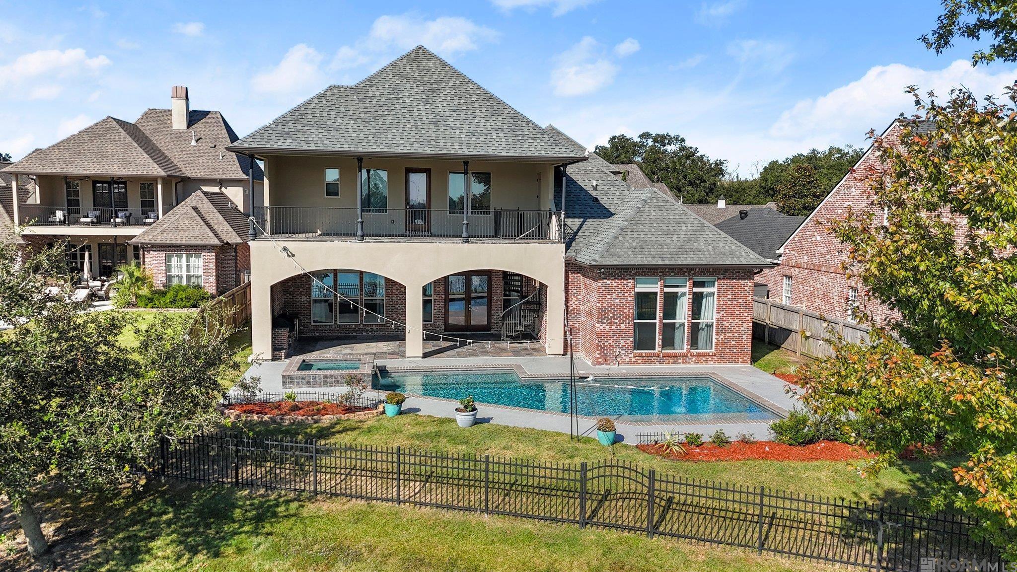 WOW WHAT A VIEW! This 5 bedroom 4 full bathroom home in sought after "Oaks On The Bluff" located in Prairieville. Pool and Lake views from the Living room, Dining room, Kitchen and Primary suite. The Living room features soaring ceilings and gas Napoleon "Dream" fireplace. The Dining Room has a built in buffet pass through.  The Primary Wing features the bedroom with views of the pool and lake. A laundry room and a beautiful bathroom with marble counters walk-in rain shower, sunken tub jetted with LED lights, double vanities and his and her closets.  Upstairs Is 2 bedrooms with private baths, additional bedroom and 1/2 bath and hidden playroom/safe room behind bookshelves.  Then theres more, a Home Theater with built -in seating and wall thru -wall Sonos rack. and kitchenette, with a spiral staircase leading to the home gym. Second laundry room, tons of storage and walk in attic.  An  Outdoor 500 sq ft patio overlooking  the Gunite pool, spa, and outdoor kitchen. This Fully automated home has an extensive amenties that is attached in documents section.