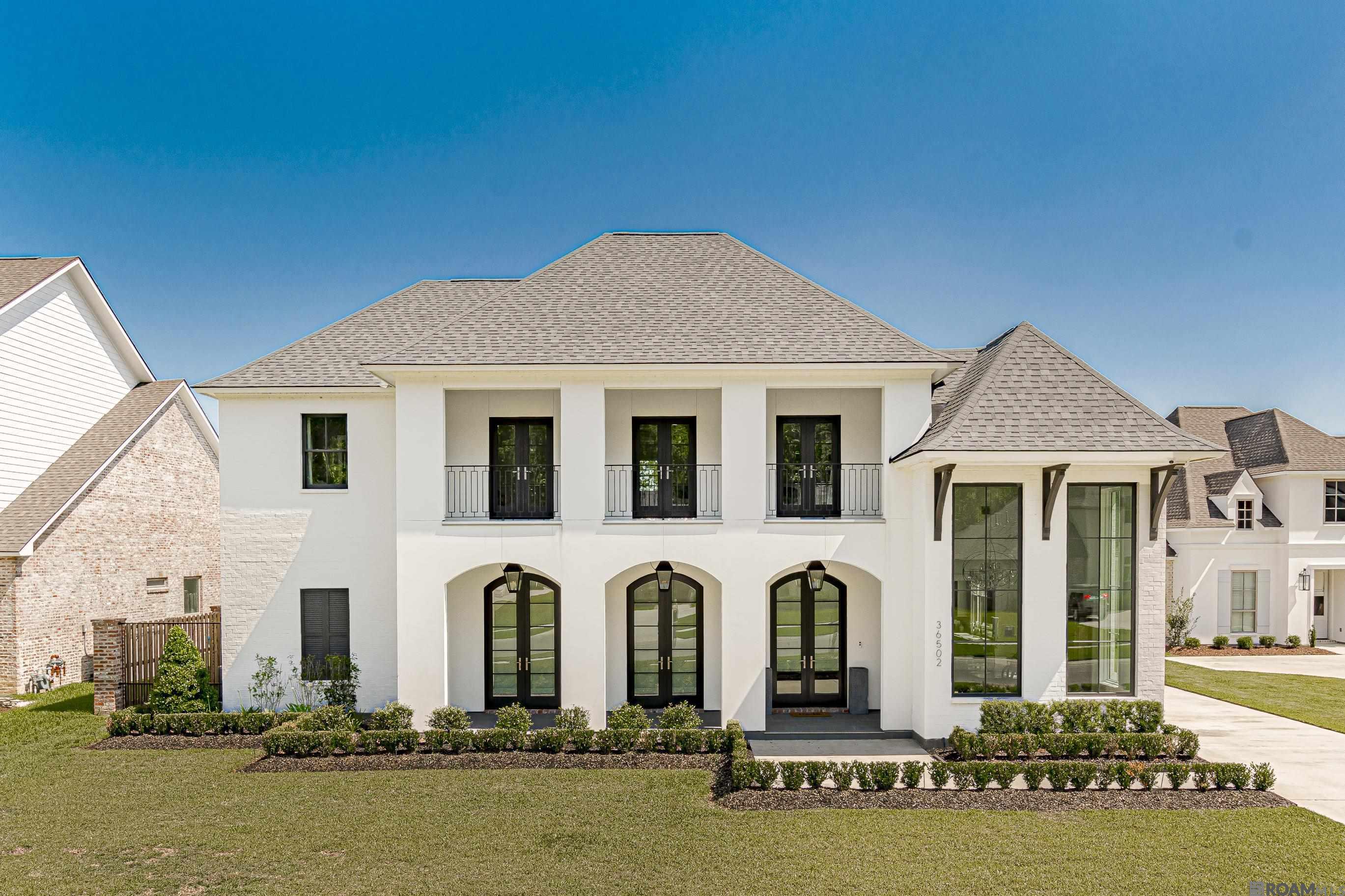 Luxury, sophistication, comfort & beauty ... 12-foot windows, interior brick columns & antique beams add a touch of warmth, welcoming you into this impeccably crafted home. The heart of the home, the kitchen, is a culinary enthusiasts dream. Custom painted cabinets, quartzite Mont Blanc countertops & a Bertazzoni 48" stainless steel range with double oven elevate the cooking experience. The vast island provides seating as well as ample storage & workspace. Down the hallway, you'll find the laundry room, a private bedroom & a full bathroom with a custom-tiled shower, perfect for guests. An office nook bathed in natural light offers the perfect space for work & study. The living room invites relaxation with its fireplace, built-in bookcases & French doors leading to the outdoor patio & pool area. Enjoy your own tranquil oasis, complete with a heated pool, outdoor kitchen & wood-burning fireplace. Retreat to the luxurious master suite, where a freestanding soaking tub & custom shower await in the spa-like bathroom. Dual custom closets provide ample storage, a bonus is the floor-to-ceiling cabinets. Upstairs, enjoy the secondary living area with balcony access and plenty of space to lounge. Add'l bedroom suites w/ private bathrooms & custom closets ensure comfort & privacy for every member of the household. The Generac generator will keep the home powered during outages.  Throughout, Pella wood-clad windows, tankless water heaters, upgraded lighting & beautiful wood trim create an atmosphere of refined elegance. With wood floors throughout most of the home & tile in the bathrooms & laundry room, every detail has been thoughtfully curated for comfort & style. Experience the pinnacle of luxury living where every amenity has been carefully considered to enhance your lifestyle.