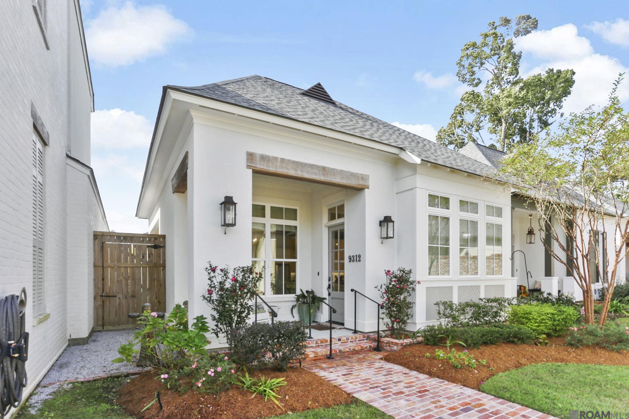 This stunning 4-year-old custom-built home is nestled in a prestigious gated community of Artisan Hill conveniently located off Jefferson Hwy offering a perfect blend of modern elegance and comfortable living. Designed with attention to detail, this residence features a spacious open floor plan, ideal for both entertaining and everyday family life.  Tons of windows offer an abundance of natural light throughout.  The gourmet kitchen is a chef's dream, complete with high-end stainless steel appliances, custom cabinetry, a large island with seating, and gleaming granite countertops. The living area boasts soaring ceilings, a cozy fireplace as its centerpiece, and views of the neighborhood pond. The primary suite is a true retreat, featuring a spa-like en-suite bathroom with a soaking tub, a walk-in shower, dual vanities, and a custom-designed walk-in closet. Secondary bedrooms are generously sized with ample closet space, perfect for family or guests. Outdoors, enjoy the private covered patio, ideal for relaxing or entertaining. The gated community adds an extra layer of security and exclusivity PLUS a whole home generator!  Move-in ready and designed to impress, this home combines luxury, location, and lifestyle in one impeccable package.