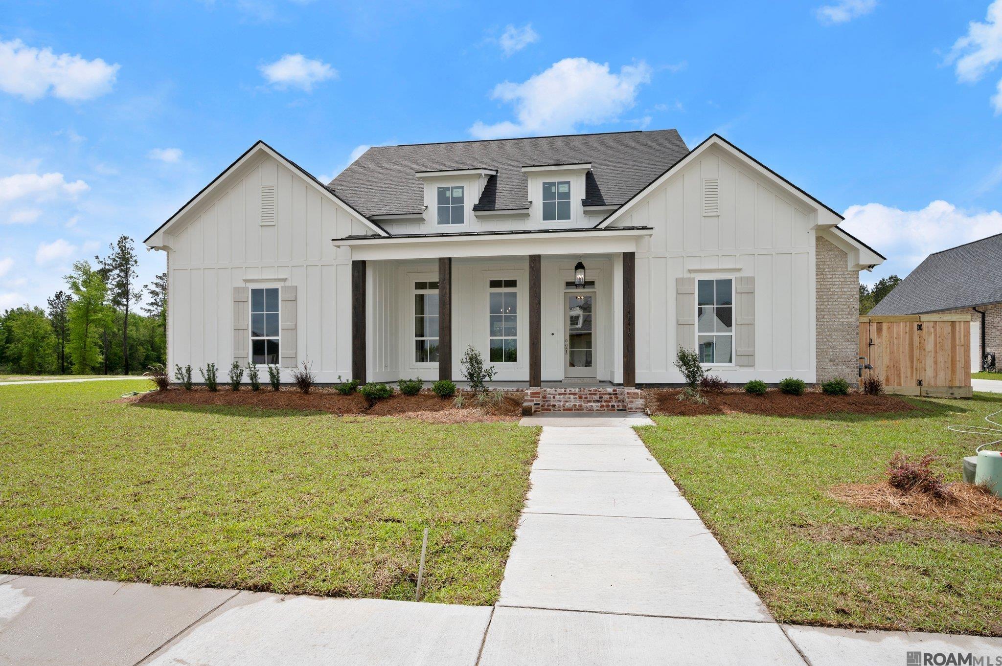Owner Financing available at 5% for qualified buyers - Great Opportunity!  New Construction in Prairieville.  This Single-Story 4 bedroom/3 bath with additional office/flex space, located on a spacious 2.12-acre lot.  The property offers a mix of modern luxury and functional living.  Open concept with natural light, wood accents and triple split floor plan.  10’ and 11’ ceilings throughout. Formal dining, breakfast room and butler’s pantry.  The living room features a wall of windows and gas fireplace.  The kitchen is a focal point with custom cabinets, high-end appliances, walk-in pantry and a multipurpose island. The primary bedroom overlooks the back acreage and boasts an en-suite bath with a luxurious free-standing tub, custom shower, large walk-in closet and separate vanity areas. The laundry room features utility sink, broom closet and adequate cabinet space. The drop zone is conveniently located just inside the side entryway and garage. A concrete pad is ready for a shop (17X43), if you decide or use it for additional parking.  A California-style 2-car garage plus an additional bay for parking or storage. Rear porch with an outdoor kitchen area, overlooking a private yard with mature trees.  Situated in the Hidden Lakes Subdivision, offering large lots (1-3 acres), ponds, sidewalks and shared community spaces.  The property perfectly balances peaceful country living with proximity to amenities, making it desirable for families or those seeking a serene retreat.