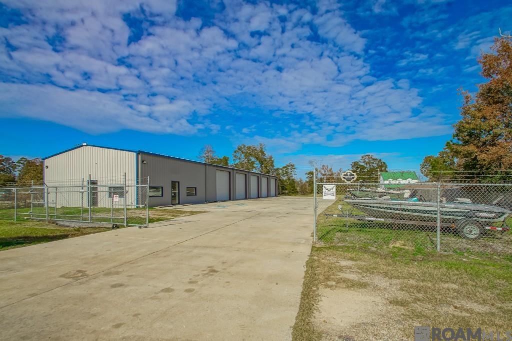 Prime commercial investment property located in Denham Springs with tenants currently in place! This versatile office/warehouse building offers 5,600 sq ft of space, featuring 1,784 sq. ft. office/retail space and 3,816 sq. ft. of warehouse space. The warehouse boasts five bays, each equipped with overhead doors, providing excellent flexibility for a multitude of uses. Situated in 2.52 acres with over 160 ft. of frontage on Florida Blvd. Property id partially fenced and gated, offering security and a lay down yard for additional storage or operational needs. Ideal for a variety of businesses looking for a well-located functional space with easy access to thoroughfares. *Structure square footage nor lot dimensions warranted by Realtor.