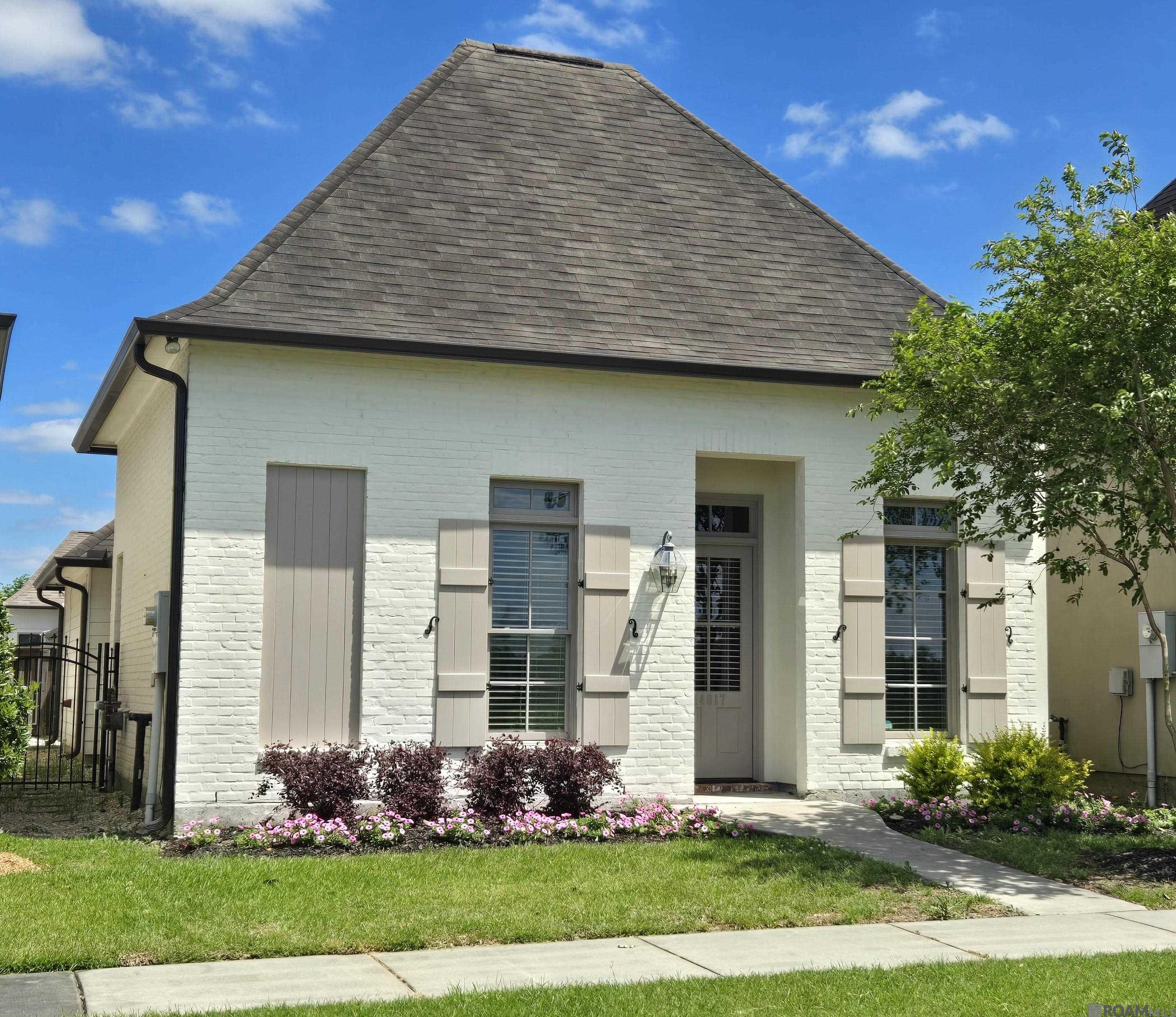Beautifully updated home in desirable Lexington Park. This immaculate 4-bedroom, 2-bath home with a garage blends modern updated with timeless charm. The attractive solid-brick facade, extended back and side patio, and wood fencing create a warm, private retreat. Inside, fresh paint, elegant millwork, crown molding, and no carpet throughout set the tone for effortless style and comfort. The split floor plan offers generous guest bedrooms with ample closets, while the primary suite features tray ceilings, a spa-like ensuite with jetted tub, separate shower, double vanity with framed custom mirrors, water closet, and a massive walk-in-closet with new metal rods. The chef's kitchen boasts a large island with storage, upgraded ceiling-height cabinetry, granite countertops, stainless steel Whirlpool appliances (including refrigerator), and a gas cook-top--perfect for entertaining. Additional highlights include 12-ft ceilings, handsome panel doors, a ventless gas fireplace, a cozy computer nook, and a well-equipped laundry room with cabinets, utility sink, and extra storage. The garage features added storage and a resin-coated floor easy maintenance. Enjoy Lexington Park's two scenic lakes with walking paths, plus a community pool and clubhouse. Ideally located near LSU, L'Auberge Casino, Perkins Rowe, Bluebonnet Mall, specialty shops, and top dining options with quick 1-10 access. A must-see opportunity in a prime Baton Rouge location. Home is virtually staged.