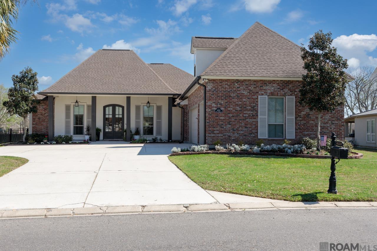 Nestled in the prestigious Pelican Point Golf Cart Community, this stunning 4-bed, 3-bath home offers 3,352 sq ft of living space with a bonus room over the garage perfect as a 5th bedroom or game room & sits on ALMOST HALF AN ACRE! Designed w/ a triple split floor plan, this home provides both privacy & functionality. The breakfast/seating area overlooks the extended patio & backyard, while the living room features a built-in bookcase framing a ventless gas fireplace, a perfect cozy retreat. The chef’s kitchen is a true showstopper, boasting a gas cooktop, double wall oven, stainless steel appliances, expansive island/breakfast bar, stone countertops, decorative backsplash, & ample custom-lit cabinetry. Unwind in the primary bedroom, where floor-to-ceiling windows showcase breathtaking views of the backyard & the beautiful golf course views. The spa-like en-suite bath includes a double vanity, extra-large walk-in closet, separate custom shower, garden soaking tub, & water closet. Elegant hardwood floors flow throughout the main living areas. Convenient mudroom by the garage entrance w/ a built-in bench & storage cabinets. Abundant storage throughout! The garage features extra cabinets & a dedicated storage closet, while inside has three hallway closets. Newly painted! Step outside to a covered & open back patio w/ an inviting outdoor kitchen complete w/ a sink and built-in grill—ideal for hosting unforgettable gatherings. Enclosed by a wrought iron fence, this home exudes charm while preserving scenic views. Living in Pelican Point means access to a neighborhood pool, splash pad, playground, baseball field, & a clubhouse with a restaurant, bar, & golf simulation.  No Flood Insurance Required! Enjoy easy golf cart access to a variety of nearby businesses & stores. With a golf course view of the 13th green & premier amenities, this home is a rare find! Don’t miss the chance to make this your own paradise & seize the opportunity to live on a golf course!