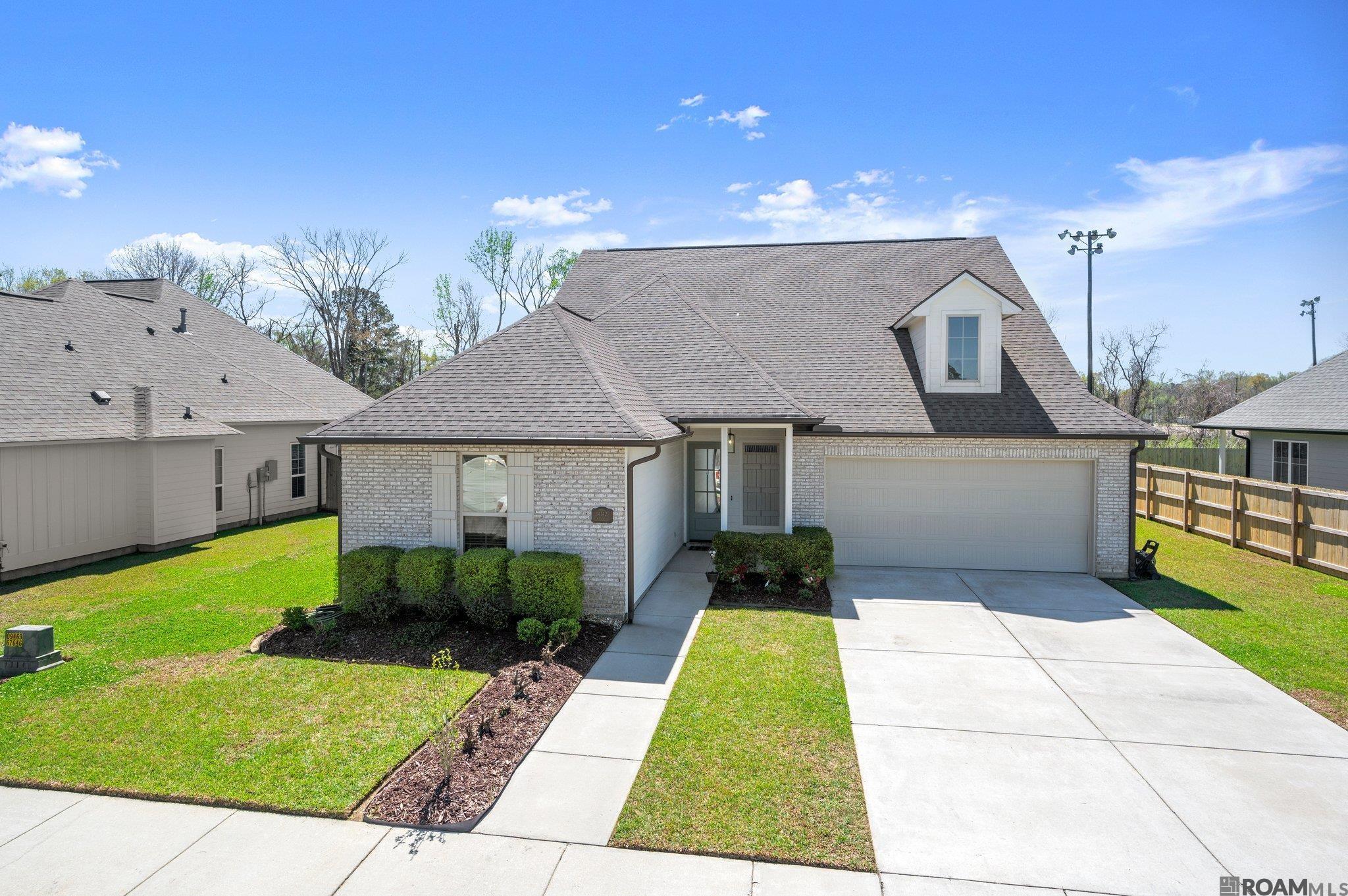 Immaculate home located in the highly sought-after Central Community School District! Boasting 5 spacious bedrooms, a bonus room, and 3 bathrooms, this stunning home is designed for both comfort and entertaining. The open floor plan is complemented by elegant crown molding, a cozy fireplace, recessed lighting, and soaring 10+ ft ceilings. The chef’s kitchen features 3 cm granite countertops, a stylish subway tile backsplash with mosaic accents, stainless steel appliances, a gas stove, a large island with a quartz top, an oversized pantry, and ample cabinet space. Every bedroom includes ceiling fans, no carpet, and generously sized or walk-in closets. The luxurious primary suite, located downstairs, offers a garden tub, separate shower, double vanity, and a spacious walk-in closet. Designed for energy efficiency, this home includes a tankless water heater, Energy Star appliances, and more! Enjoy peaceful lake views from the front porch, along with countless thoughtful amenities throughout the home. Situated in Flood Zone X, this home is a must-see! Schedule your private showing today!