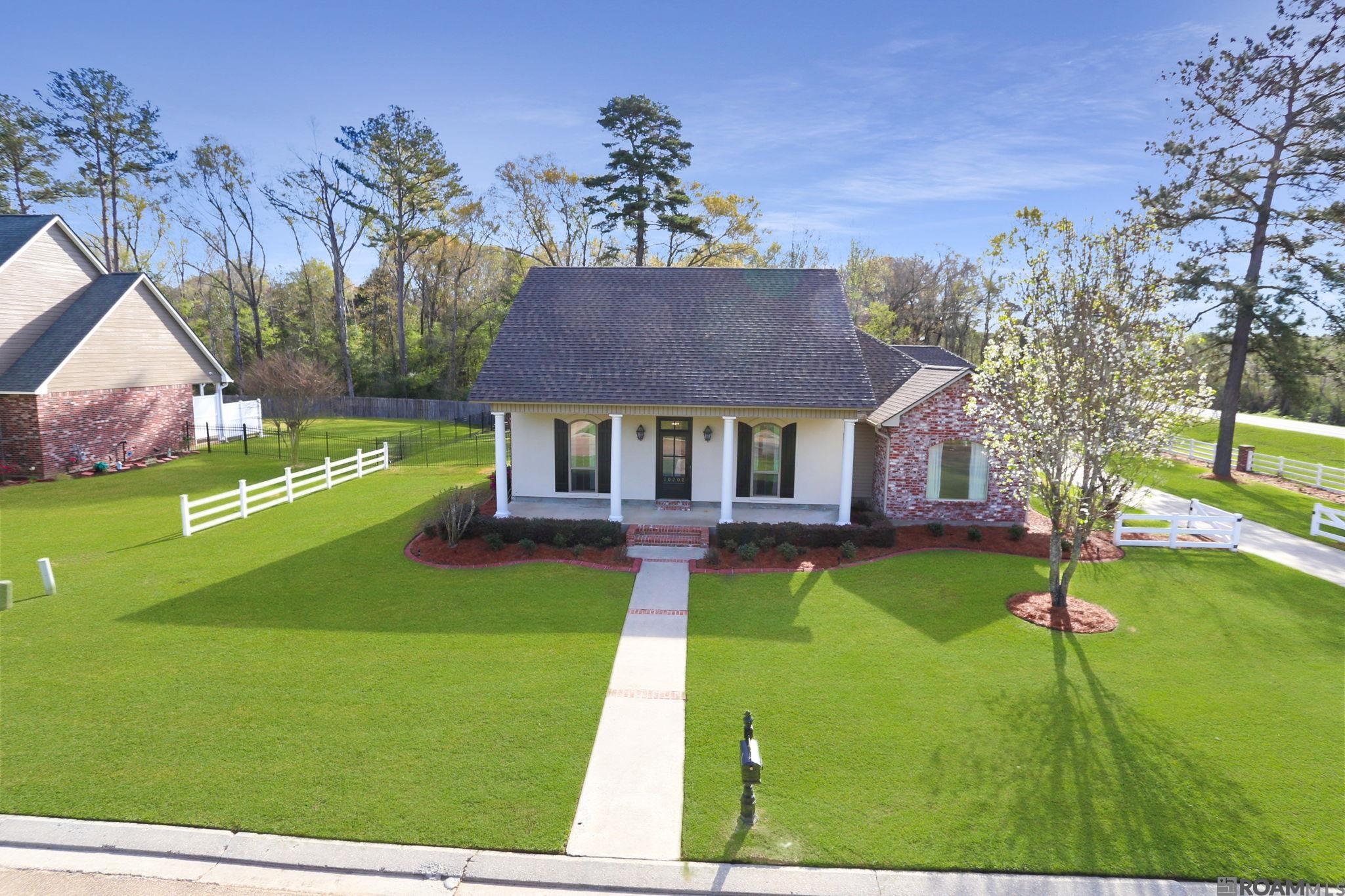This stunning Acadian-style home in Magnolia Lakes Estates offers 4 bedrooms, 3.5 bathrooms, an office, and a private mother-in-law suite, all within one of Central’s most sought-after neighborhoods. Custom-built by Gafford Builders in 2003, this home boasts a brand-new roof (2024), 2 new front windows (2024), a new water heater (2024), and modern color choices. The gourmet kitchen is a chef’s dream, featuring custom cabinetry, granite countertops, a top-of-the-line 5-burner gas cooktop with built-in oven and auxiliary oven, stainless steel appliances, an undermount sink, a spacious pantry, and a casual dining area. The formal dining room opens into a beautifully designed living room with a gas log fireplace, built-ins, and crown molding. The private master suite is bright and spacious, offering a jetted tub, separate stand-up shower, dual vanities, a water closet, and a large walk-in closet. The first-floor mother-in-law suite includes a full bath and is located off the kitchen. Upstairs, two generously sized bedrooms with a full bath provide an ideal space for children or guests. Additional features include a covered patio, loads of storage, and a dual 2-car garages with an attached workshop/storage/man cave. Situated in Flood Zone X (did not flood in 2016 ), this move-in-ready home is just minutes from restaurants, shopping and Central Schools! HOA includes access to stocked private pond in the rear of the subdivision! Central Schools!  Don’t miss out—schedule your private showing today!