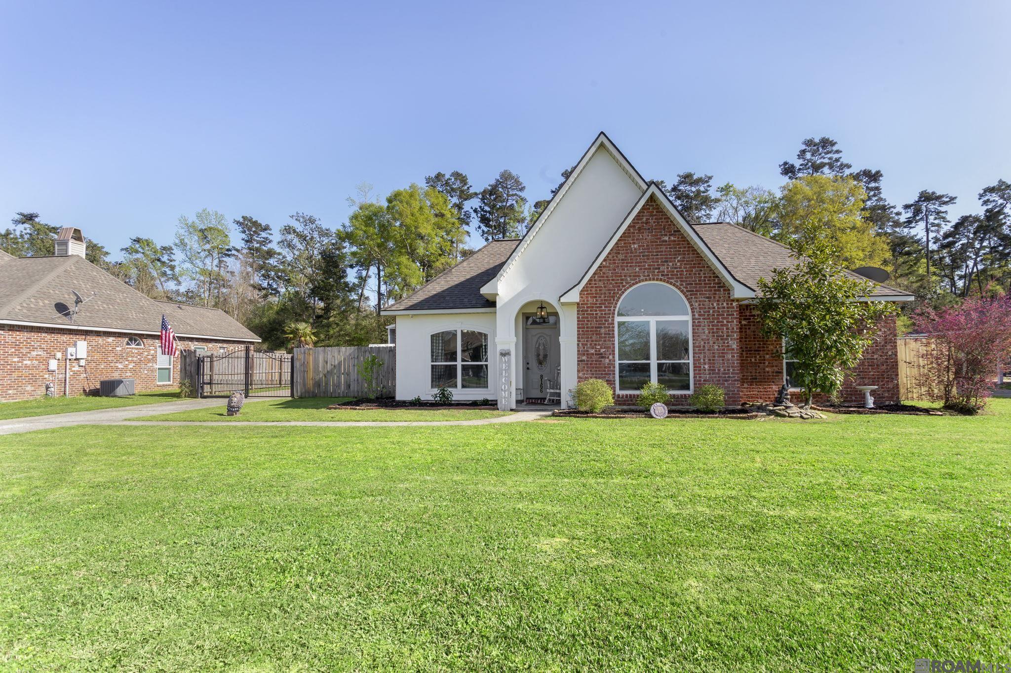 Discover the charm and convenience of this beautifully maintained home, nestled in Acadiana Place Subdivision. This property offers three cozy bedrooms, including a spacious primary bedroom, and two full bathrooms, ensuring comfortable living spaces for all. Featuring a generous 1,468 square feet of interior space, the home is highlighted by concrete floors and a welcoming wood-burning fireplace. The kitchen is a chef's delight with leather-finish granite countertops, stainless steel appliances, and floods of natural light that make cooking a pleasure. Outdoor living is just as splendid with a fully fenced backyard that includes a covered patio with a bar, perfect for entertaining and relaxation. Additionally, the property boasts a sizable 24 x 36 metal shop and an 18 x 19 lean-to off the carport for ample storage solutions. The electric wrought iron gate adds a touch of sophistication while enhancing security and privacy. Located in a tranquil neighborhood known for its excellent schools and proximity to great shopping and dining options, the home is also near several local attractions. Train Station Park, Kinchloe Lloyd Baker Park, and the Denham Springs Antique Village are all within easy reach, enriching your living experience with convenience and community charm. Whether you're enjoying the spacious workshop, hosting a backyard barbeque, or visiting the nearby parks and markets, this home offers a perfect blend of comfort, style, and convenience. A true gem in Denham Springs, it awaits to bring joy and ease to your daily life.