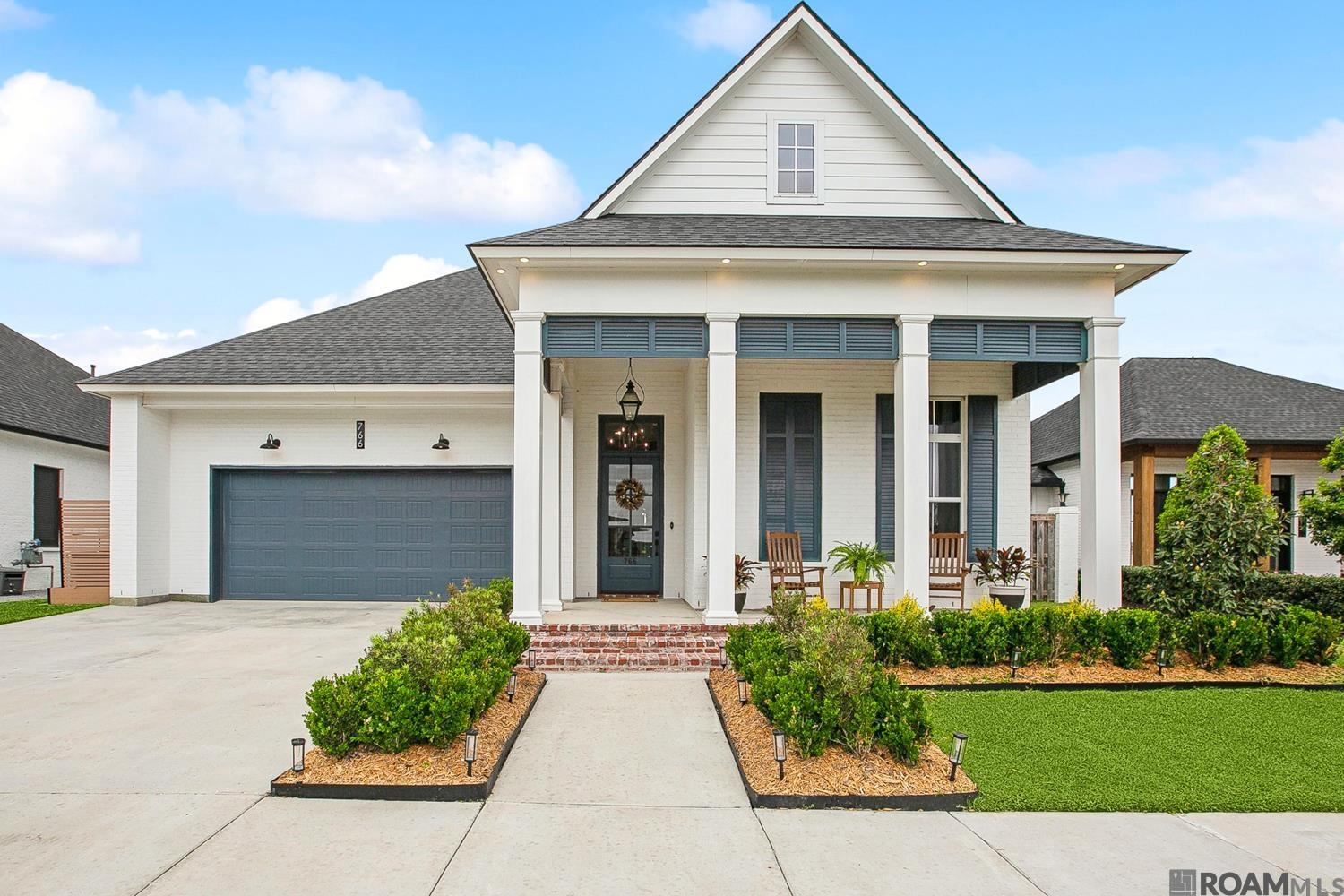 This exceptional 4-bedroom, 3-bath custom home, built by Aucoin Homes, is designed for comfort and style. The inviting front porch leads into an welcoming foyer with beautiful lighting.  The open floor plan features a cathedral ceiling, wood flooring throughout, upgraded lighting, and elegant brick and beam details. The chef’s kitchen is a standout with its oversized island, Dolomite countertops, 36-inch range, additional wall oven, farmhouse sink, and an abundance of custom cabinetry with glass-front upper cabinets and lighting…an added feature is a coffee station/bar area and generous walk-in pantry. The dining room and living area are enhanced by wood flooring, brick and beam accents, a cathedral ceiling, and Accordion doors that let the outside in. This thoughtfully designed home features a generous primary suite with a sitting area, a spa-inspired en suite with a soaking tub, custom shower, dual vanities, and an expansive walk-in closet with built-in dressers that seamlessly connect to the laundry room. A guest suite with a private bath, a home office, a mud/drop zone, and two additional bedrooms with a full bath complete this 3-way split floor plan, ensuring privacy and functionality. Designed for effortless entertaining, the outdoor living space includes a covered patio with a brick fireplace and a full outdoor kitchen, all overlooking breathtaking lake views and a majestic oak tree. The fully fenced backyard offers both privacy and serenity. A spacious 2-car garage completes the package. Enjoy all the best of Conway living with access to lakes, parks, a community pool and fitness center, and a community pavilion for hosting concerts and events. Don’t miss this exceptional home—schedule your private tour today!