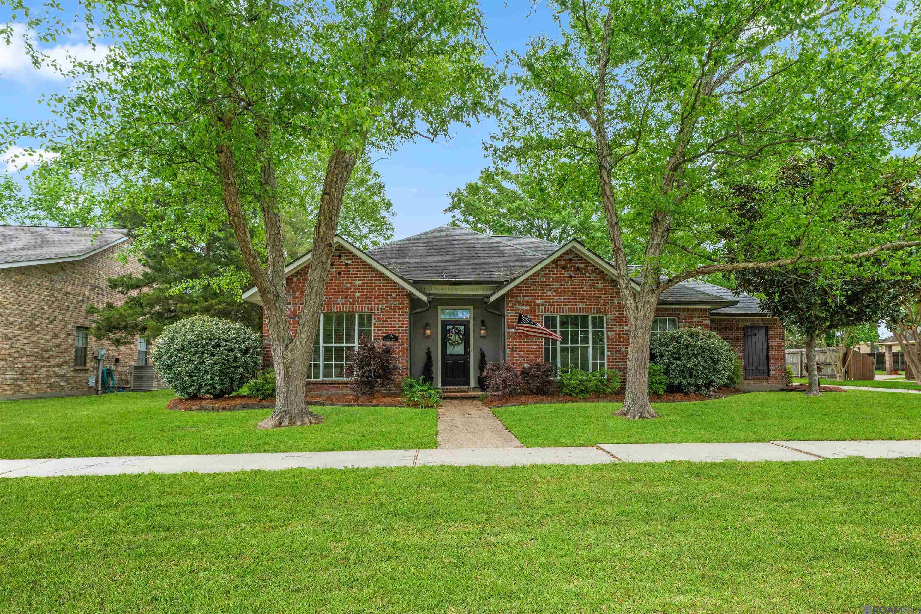 Well maintained 3 bedroom, 2 bath home with a spacious backyard, an in-ground pool, and a separate workshop/garage in the wonderful Cypress Park Subdivision. Prime location in the heart of Zachary within walking distance to Zachary Elementary and the neighborhood park. Inside, the home features durable laminate wood and ceramic tile flooring throughout, making for easy maintenance. The large living room centers around a cozy fireplace with oversized windows on either side that fill the space with natural light and provide views of the backyard. The kitchen is both stylish and functional, with granite countertops, tile backsplash, a gas stove, and plenty of storage space. Adjacent to the kitchen, the formal dining room offers a comfortable space for gatherings and meals. The split floor plan offers privacy, with the primary bedroom located on its own side of the home. The ensuite bathroom includes an updated double vanity, a large jetted tub, and a huge walk-in closet with convenient built-in storage. Outside, the expansive and fully fenced backyard is a true highlight of this home, ready for fun, entertaining, and/or relaxation. A large covered patio provides a great shaded space and there is gated access to the 2 car carport and attached storage room. Escape the heat and enjoy summer days with the large in-ground saltwater pool. There’s still plenty of green yard space and the 20x24 workshop with an overhead loft is perfect for additional storage and provides a great flex space for a home gym, hobbies, game room, or whatever fits your lifestyle. This home has so much to offer and in a great location! Call to schedule your showing today!