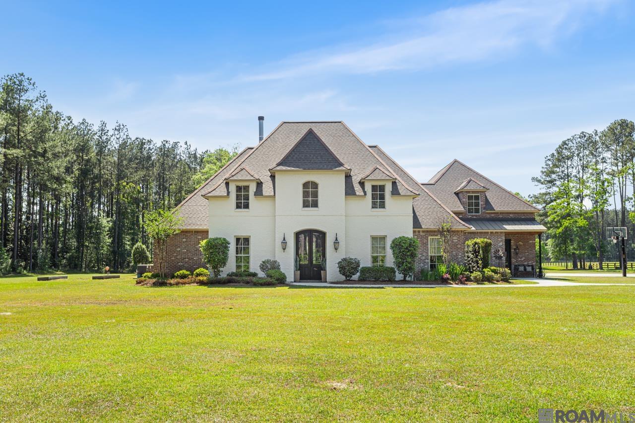 Classy Country Living doesn’t get any better than this. This 4089 Sq Ft home is purposefully arranged for privacy on 20.57 Acres.  The land, all in zone x, boasts a mix of forested plantation pine, fenced and cross fenced pastures, as well as areas of  professionally maintained landscaping.  The expansive pastures, designer barn, outdoor kitchen, gunite pool, along with many other amenities are sure to be the private oasis that you’ve dreamed of. This elegant home is nestled at the end of a gated private drive setting in the coveted Watson area in Livingston Parish. The 5 BR/5 Bath home has a split floor plan that is spacious and open making it perfect for entertaining. There are four bedrooms downstairs; two that share a Jack-N-Jill Bath.  The living room boasts a 12' ceiling and opens to an outside living area with fireplace and outdoor kitchen. This area overlooks the gunite pool with a stocked pond beyond. The chief’s kitchen has high-end Thermador appliances, leathered granite countertops, and custom cabinets. The outdoor kitchen has built in Blaze Appliances and leathered granite countertops. The home has a whole home 36KW Generator.  Please see Attached Amenities in Documents for more details about this amazing home.